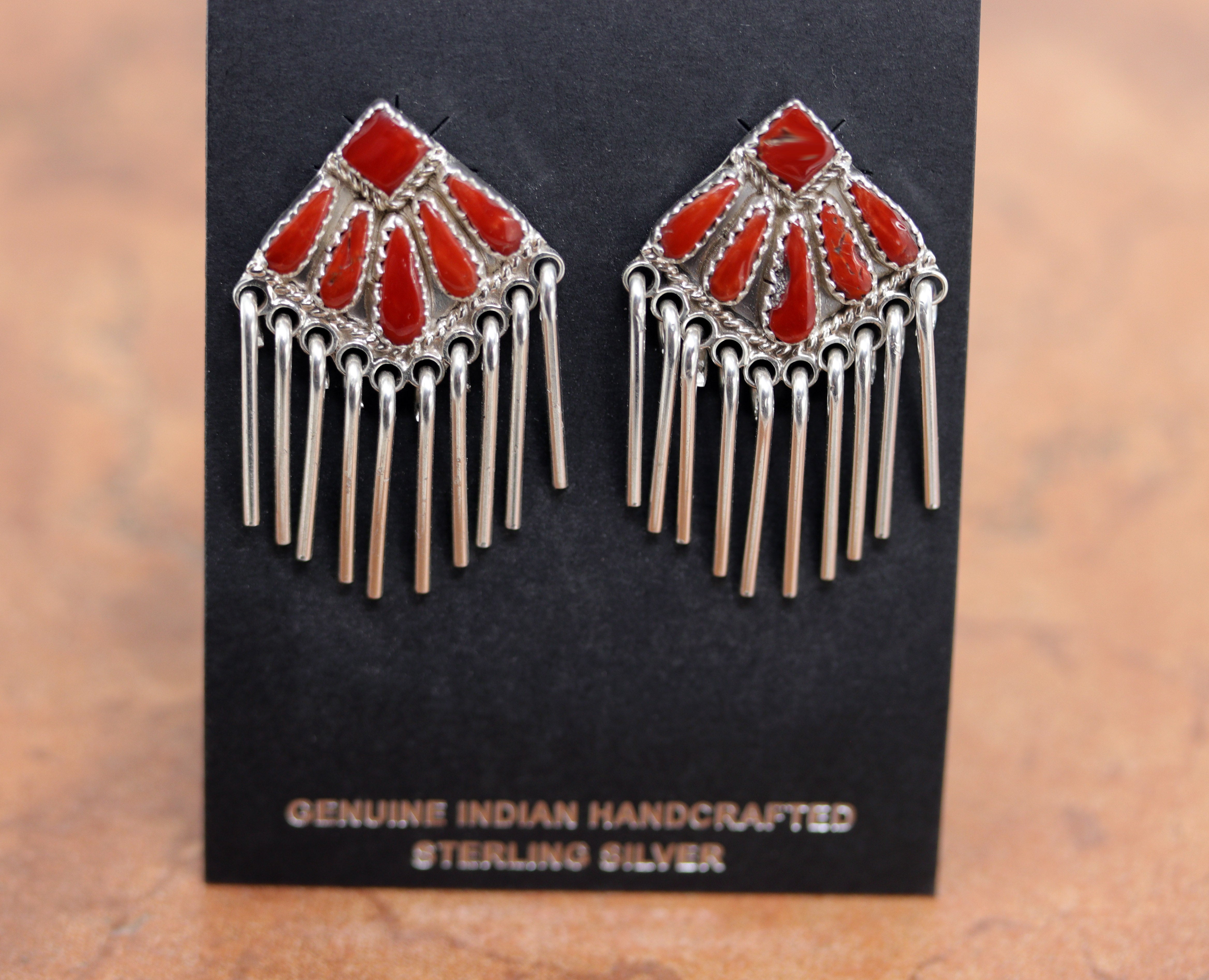 Gorgeous Zuni Native American earrings. They are made from sterling silver and coral. Each earring is 1 5/8" in length, and about 1" in width.