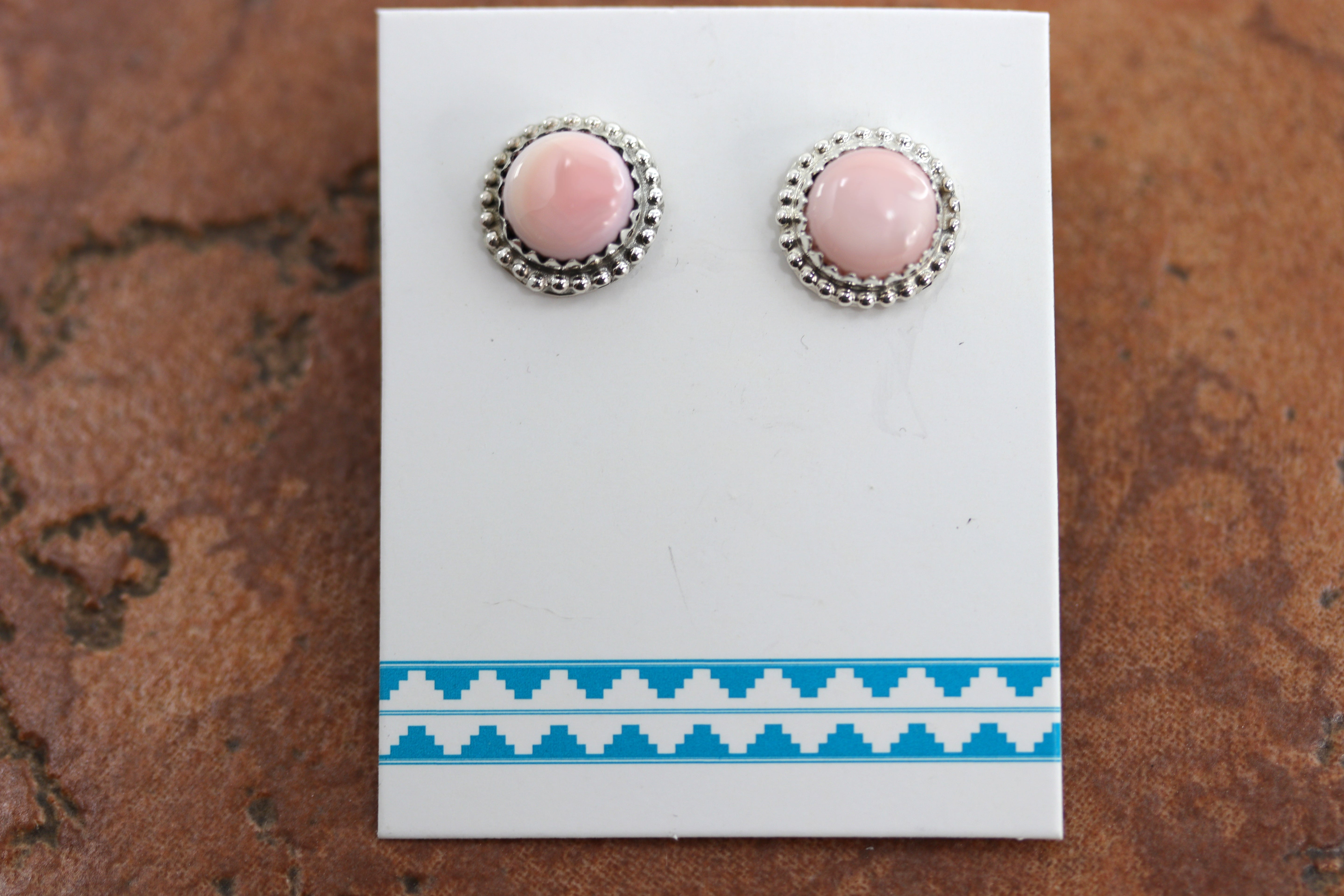 Beautiful Navajo stud earrings. They are made from sterling silver and pink quartz. The earrings are 1/2" in diameter.