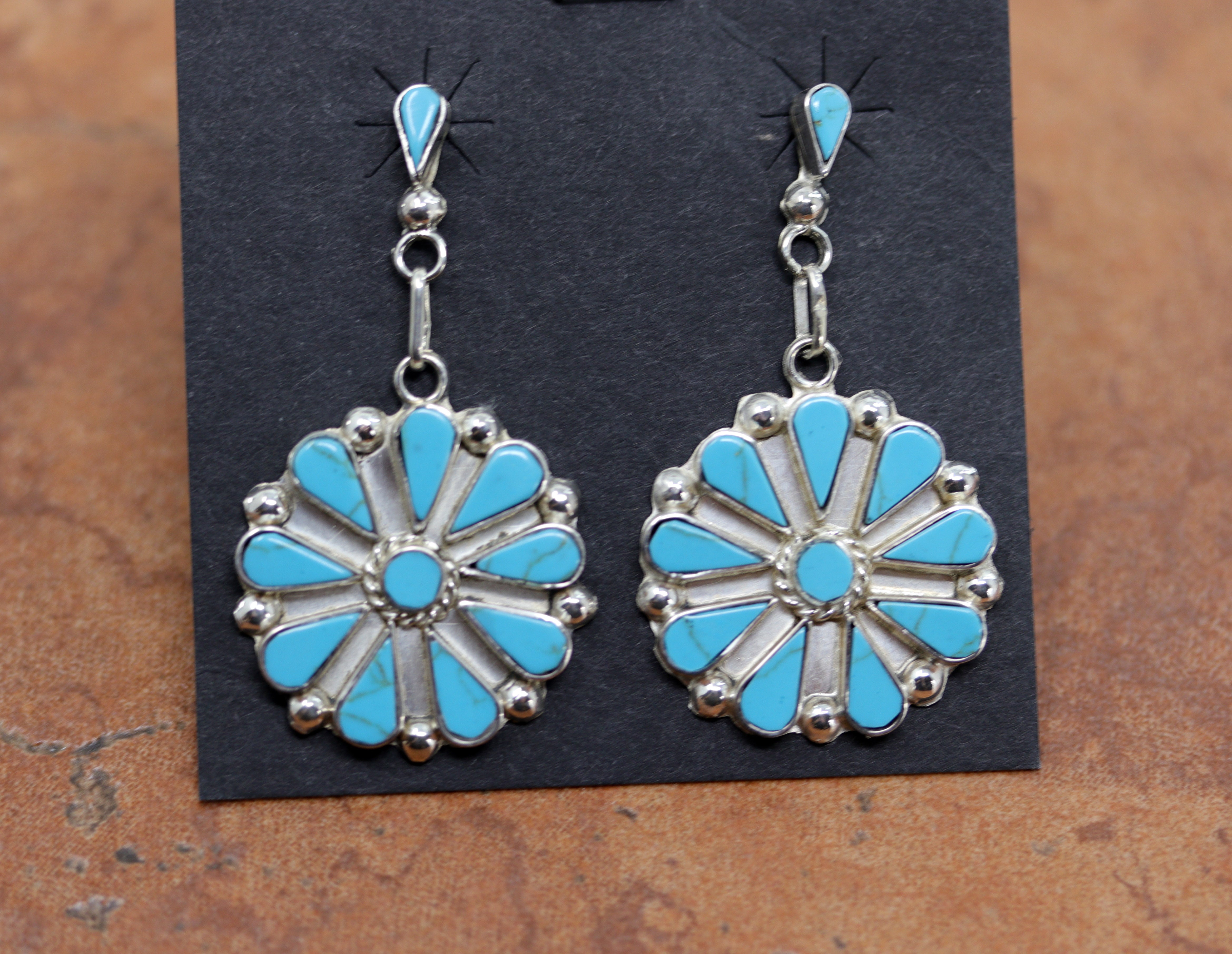 Gorgeous Zuni Native American earrings. They are made from sterling silver and turquoise. Each earring is&nbsp;1 7/8" in length, and about 1 1/8" in width.