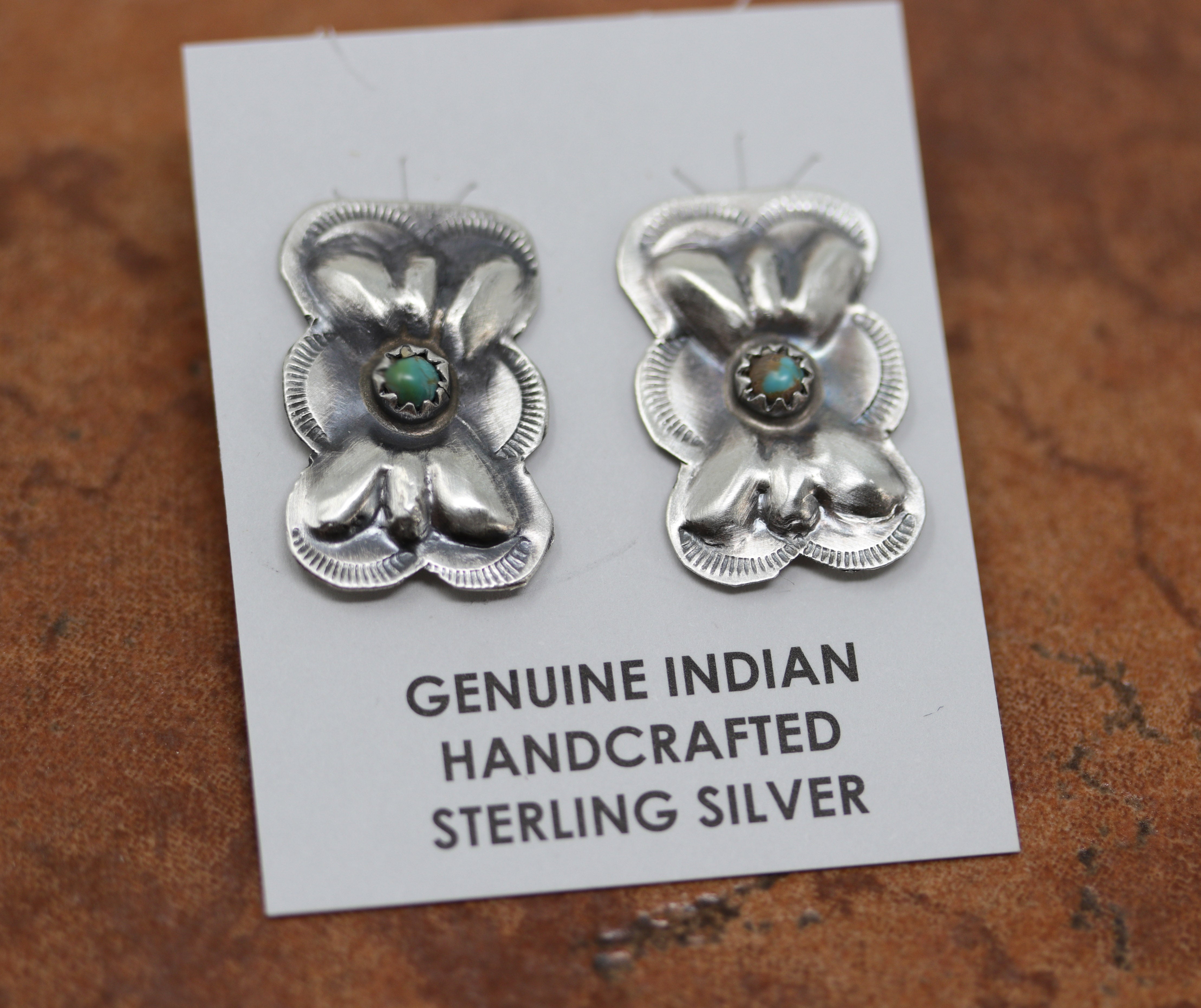 Navajo Native American earrings. They are made from sterling silver and turquoise. The earrings are 1" in length including the hook and 3/4" in width.