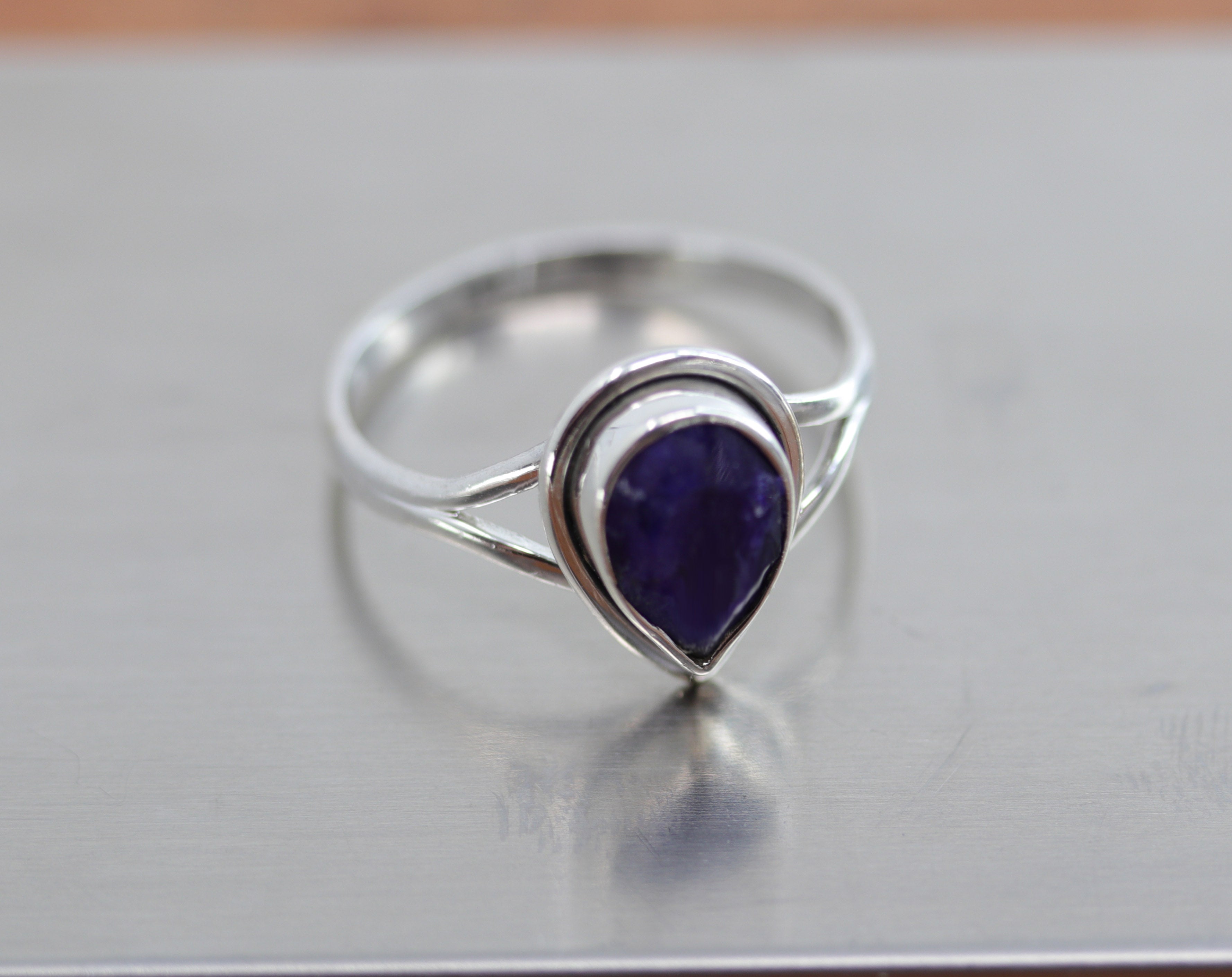 A beautiful Southwest Style tear drop shaped gemstone ring made from sterling silver and sapphire. The ring size is 8 and it is 5/8" in length. 