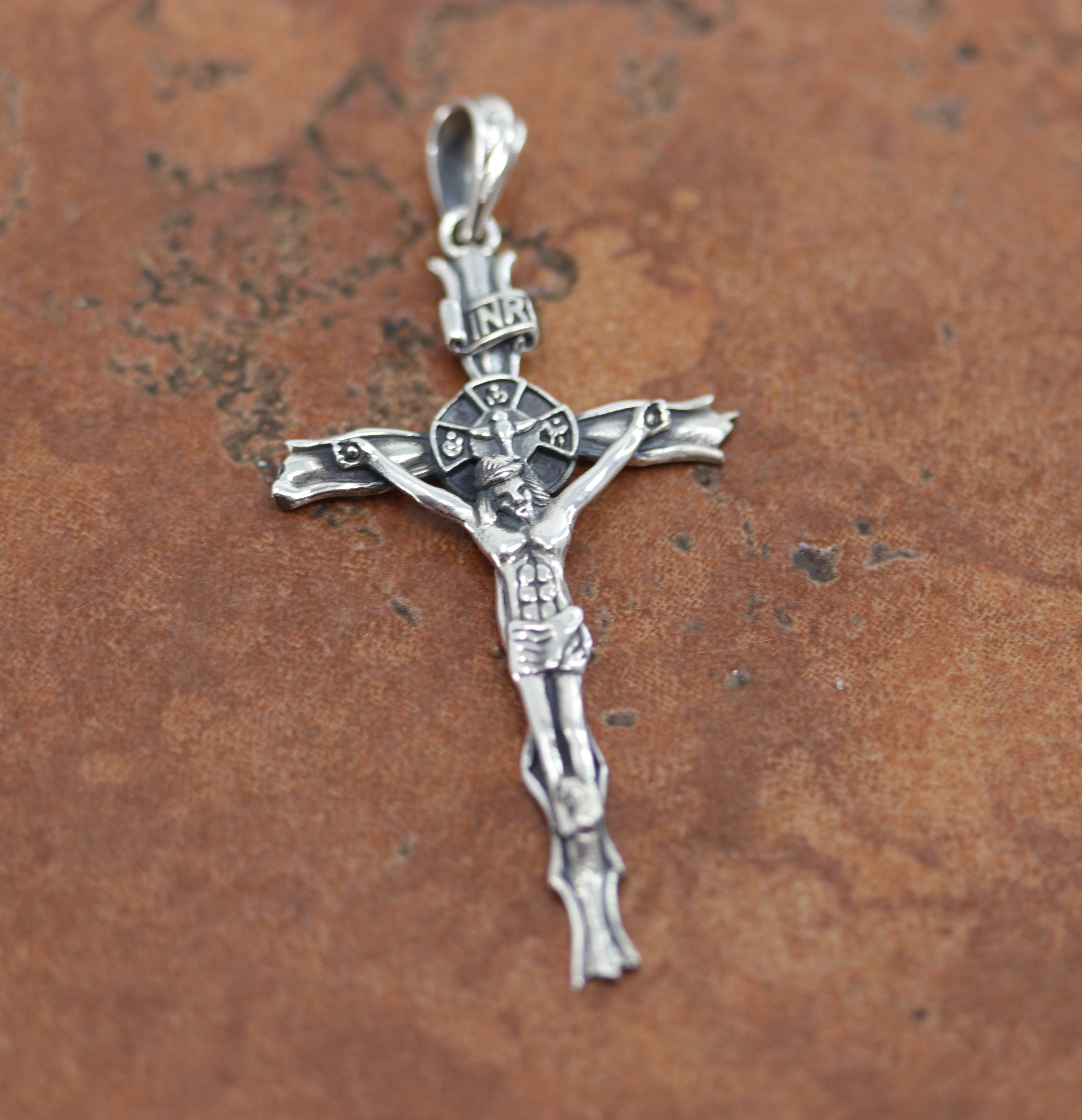 A crucifix pendant made from Sterling Silver. It is about 2 1/2" in length including the bail, and about 1 1/4" in width.