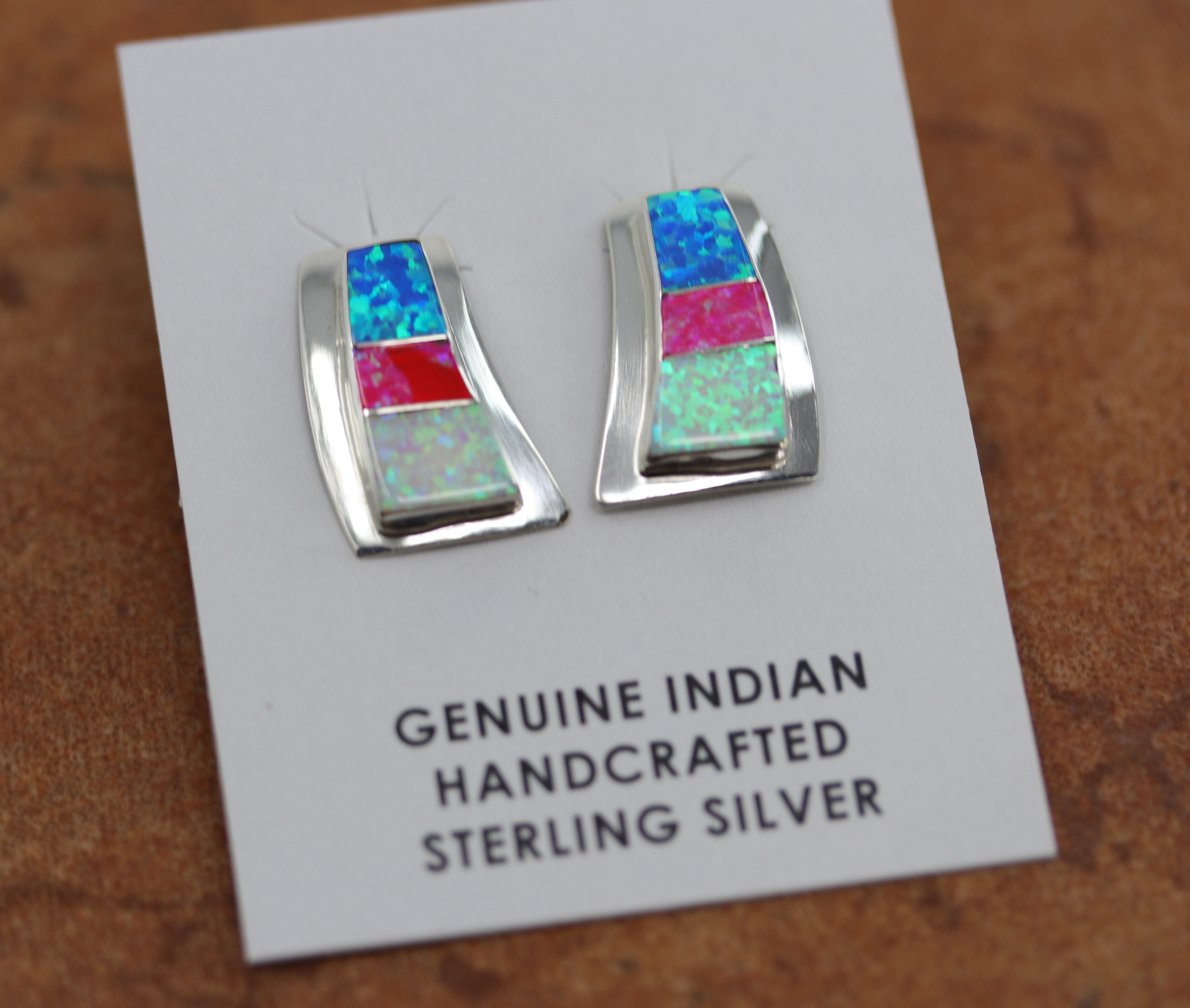 They are made from sterling silver and created opal. Each earring measures about 7/8" in length and 1/2" in width.&nbsp;