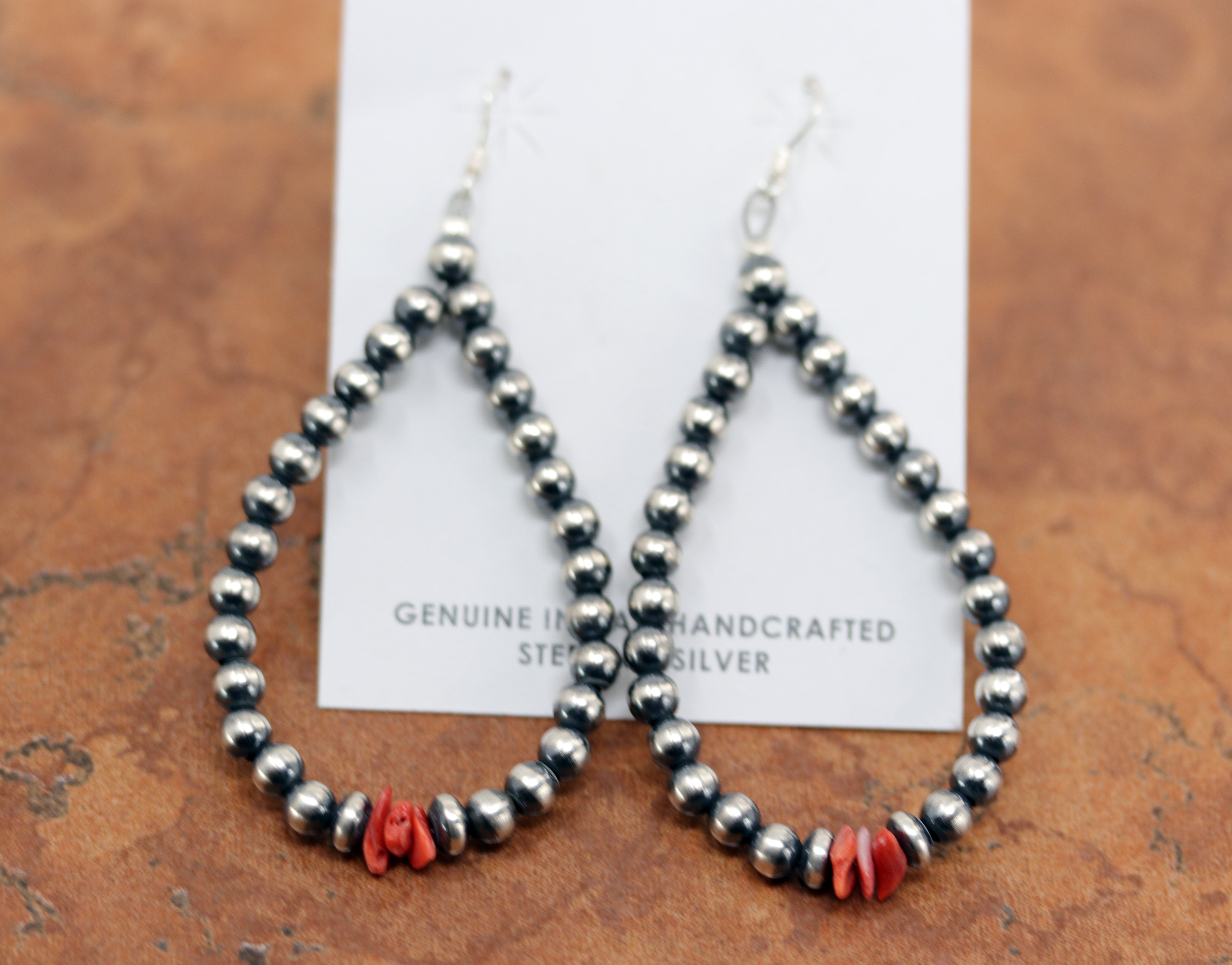 Beautiful Navajo Native American Earrings. They are made from sterling silver and coral. The earrings about 3 3/8" long including the hook and 1 1/2" wide.