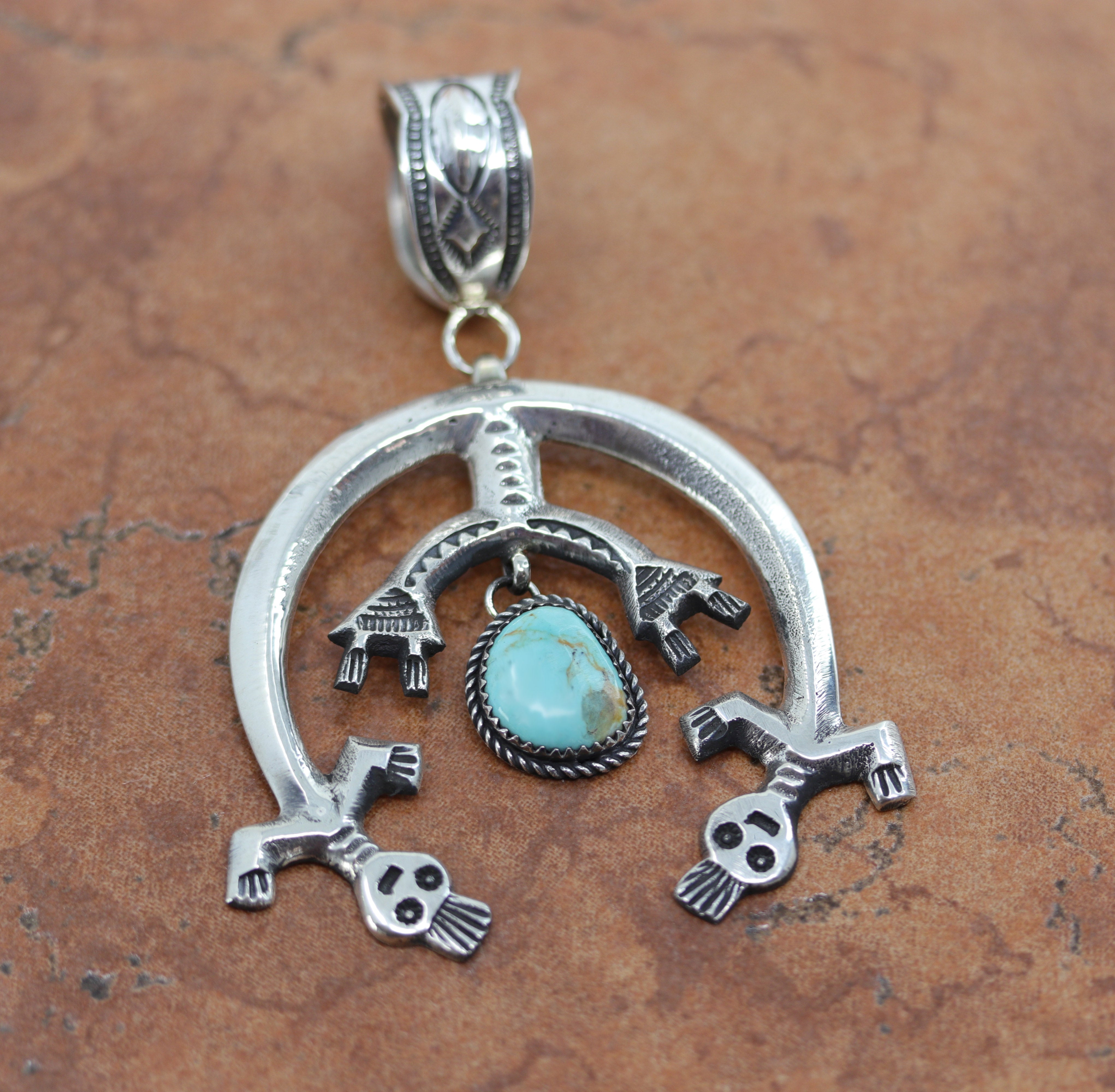 A beautiful Navajo Native American Pendant. It is made from sterling silver and turquoise.&nbsp; It is 3 1/2" long and about 2 1/4" wide.