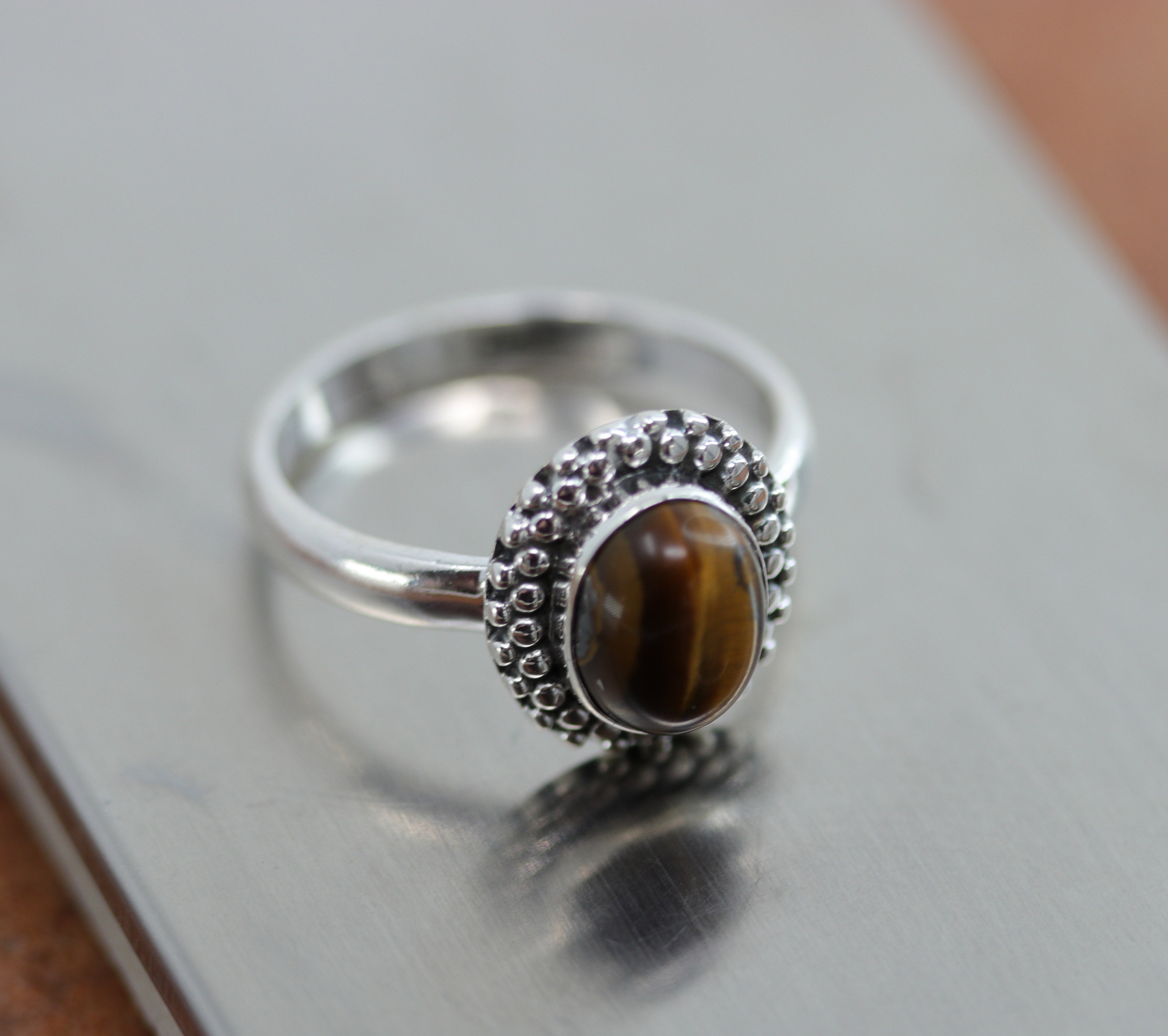 A beautiful Southwest Style gemstone ring made from sterling silver and tiger eye. The ring size is 8 and it is 5/8" in length. 