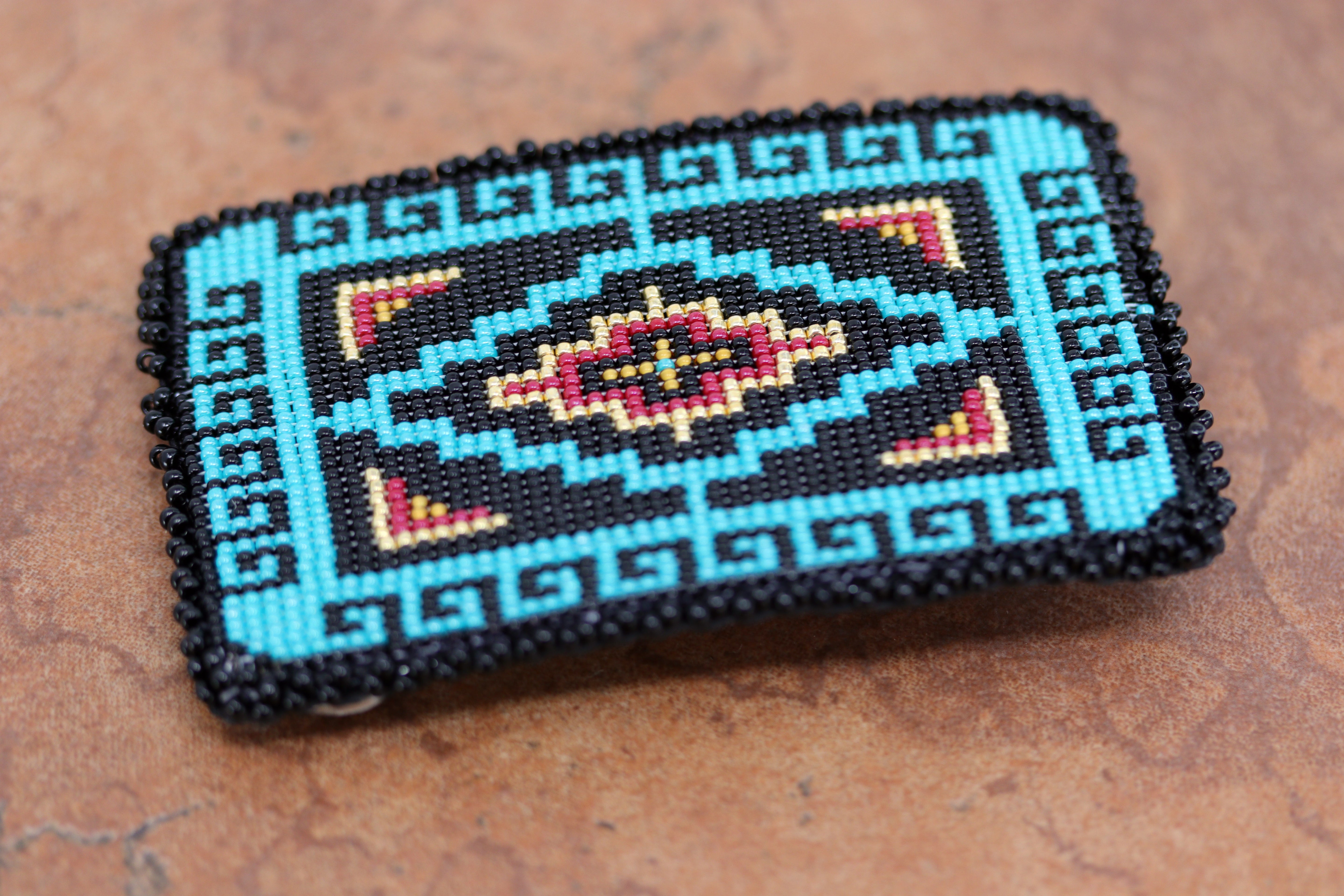 Authentic Navajo Native American Belt Buckle. It is made from sterling silver and mostly blue and black beads. It is about 3 1/2" by 2 1/4". It will hold a belt up to 1 1/2" wide.