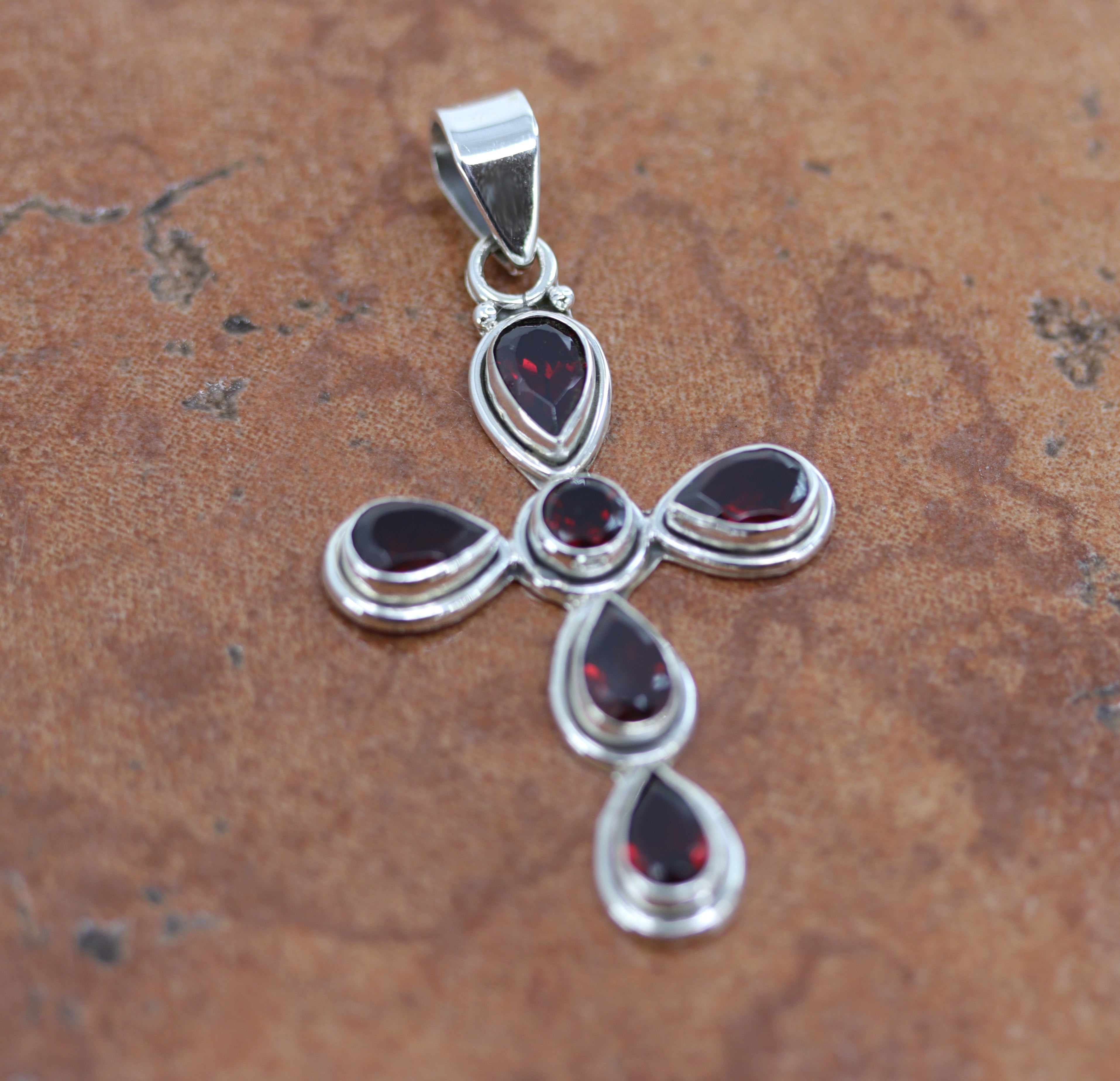 Beautiful pendant made from Sterling Silver and garnet. It is about 2 1/4" in length including the bail, and about 1 1/4" in width.