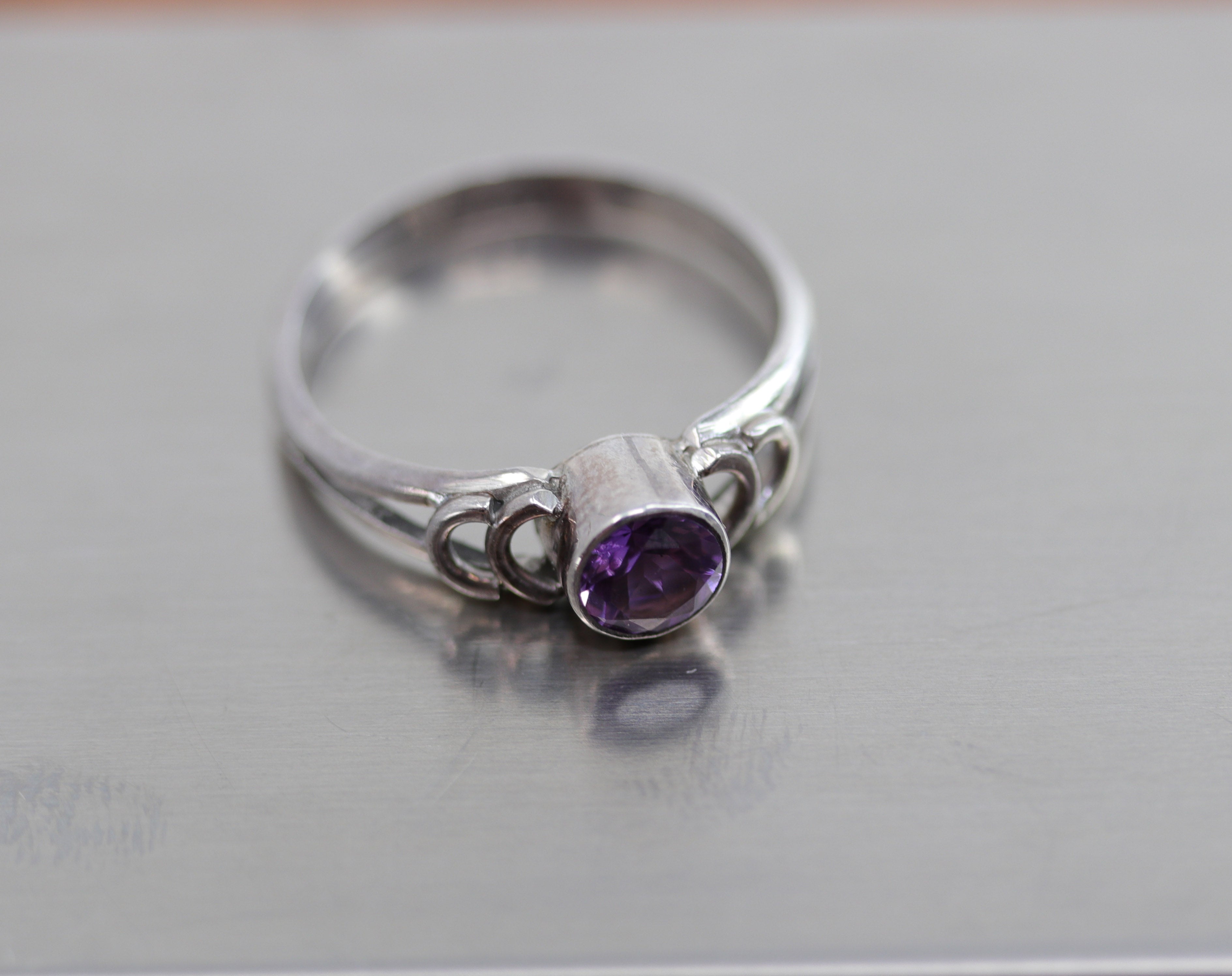 A beautiful Southwest Style gemstone ring made from sterling silver and amethyst. The ring size is 6 1/2 and it is 1/4" in length.