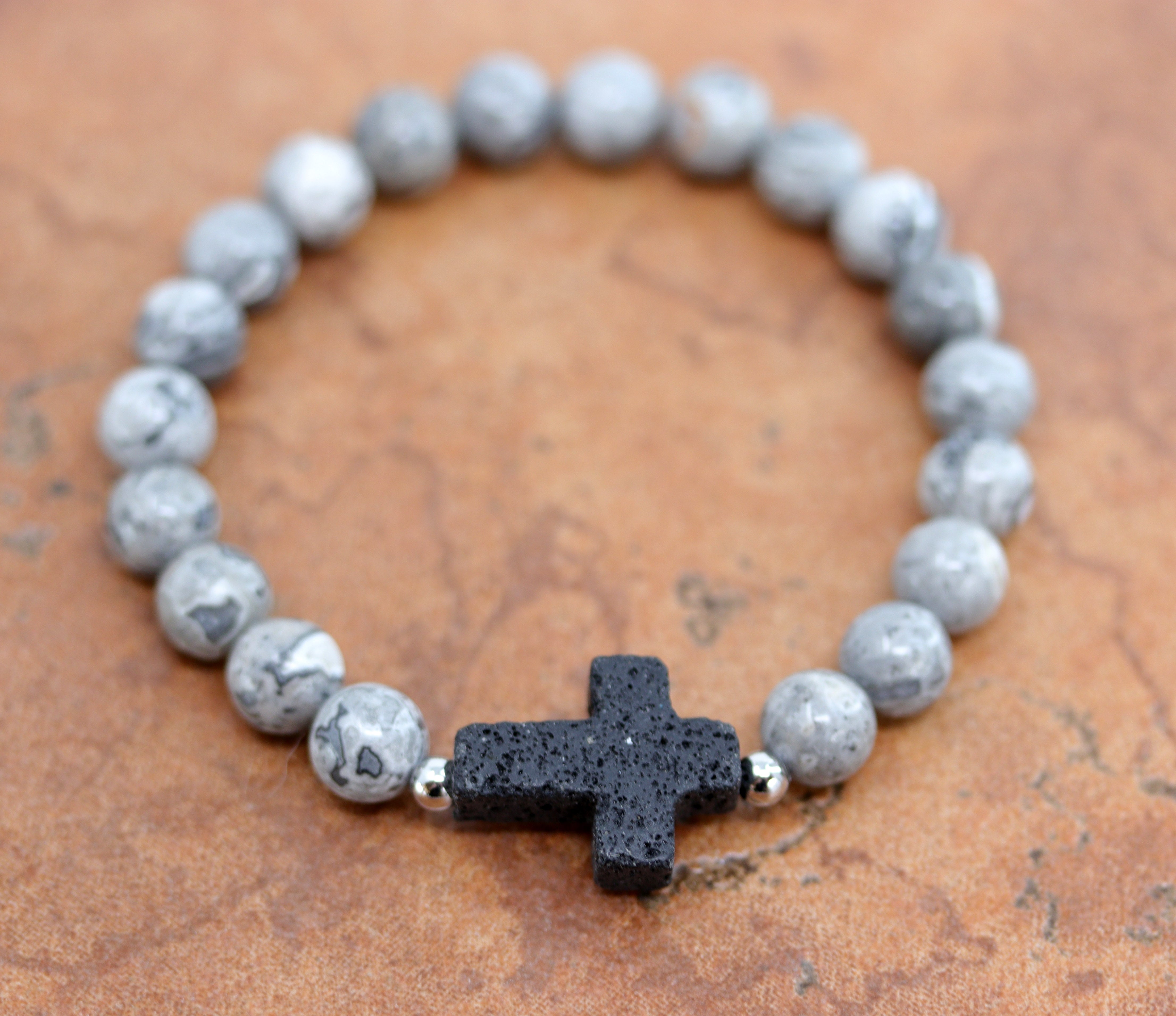 A beautiful beaded black labradorite bubble bracelet with a cross on it. It fits sizes 6" (more loose) to about 9" (tighter fit). The width of the bracelet is 3/8" at the beads, and the cross is 7/8".&nbsp;