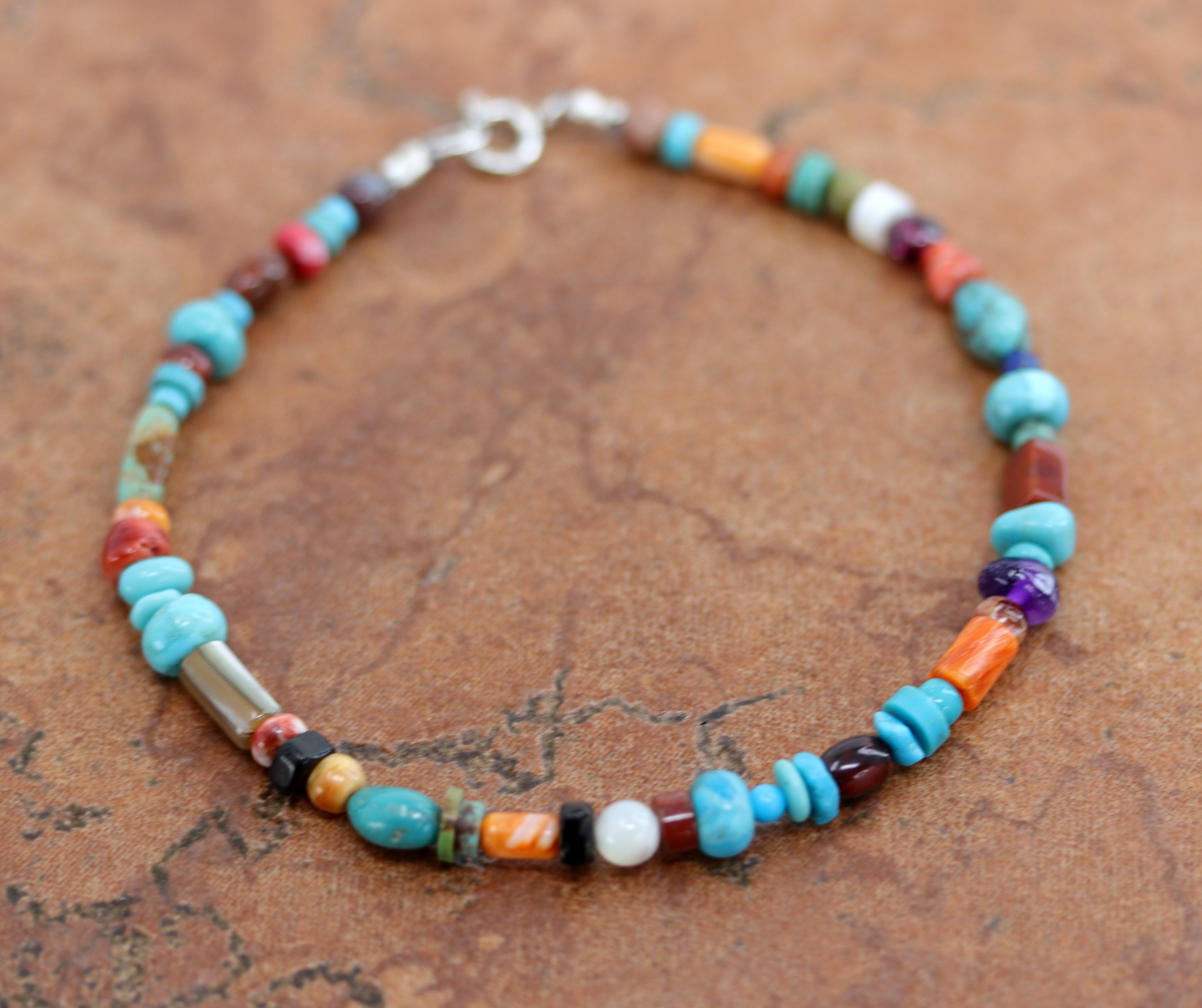 Lovely Navajo Native American Multi-Color Nugget Bracelet. It is about 8 1/4" from end to end and the width is 5/16" at the widest point.