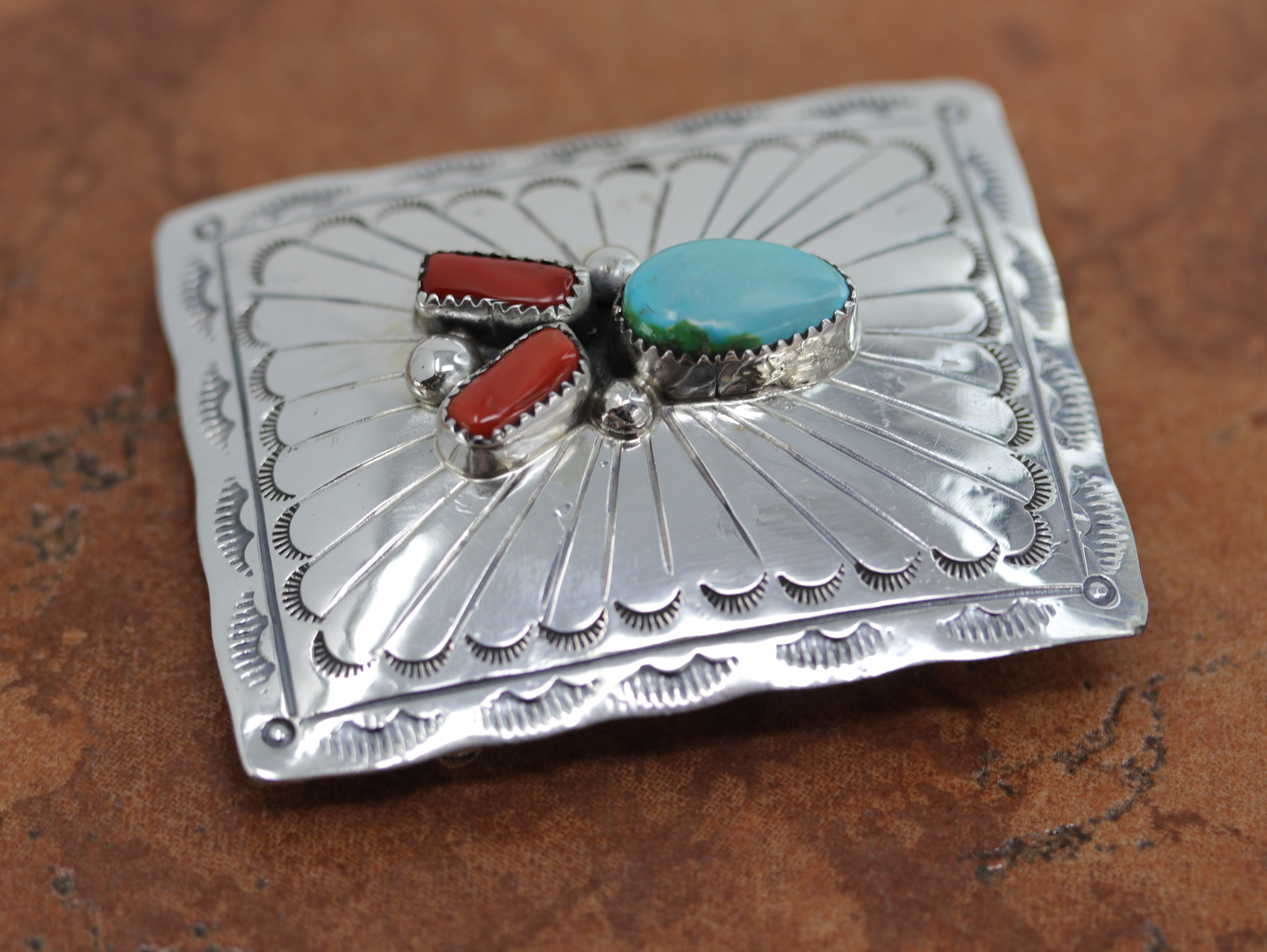 Authentic, Navajo Native American Belt Buckle. It is made from sterling silver, coral, and turquoise. It is stamped Sterling. It is 2 5/8" by 1 7/8". It will hold a belt up to 1 1/2" wide.&nbsp;