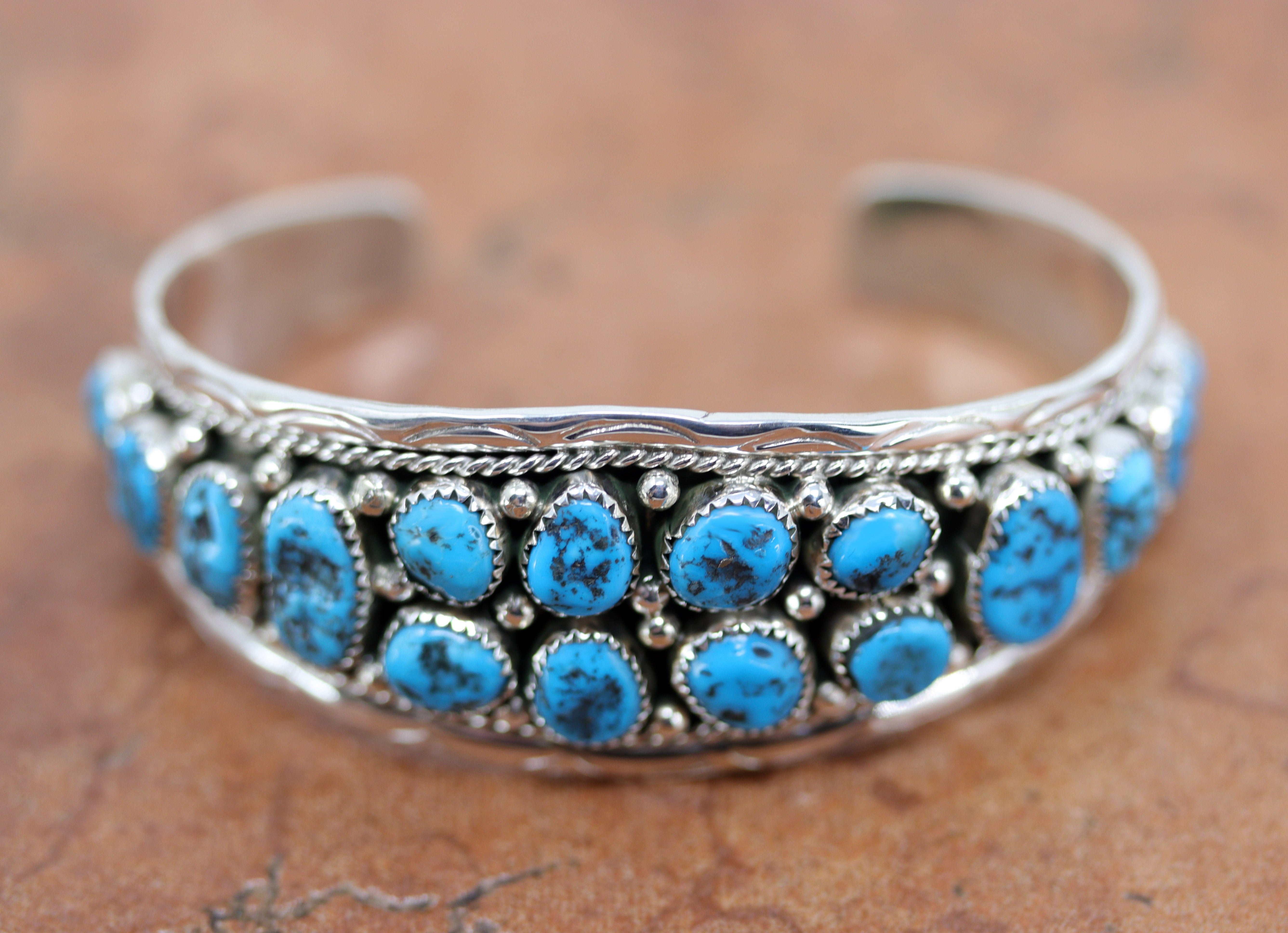 Beautiful Navajo Native American bracelet. It is made from sterling silver and turquoise. It is about 5 1/4" around and 1" wide. The opening is about 1", and partly flexible.