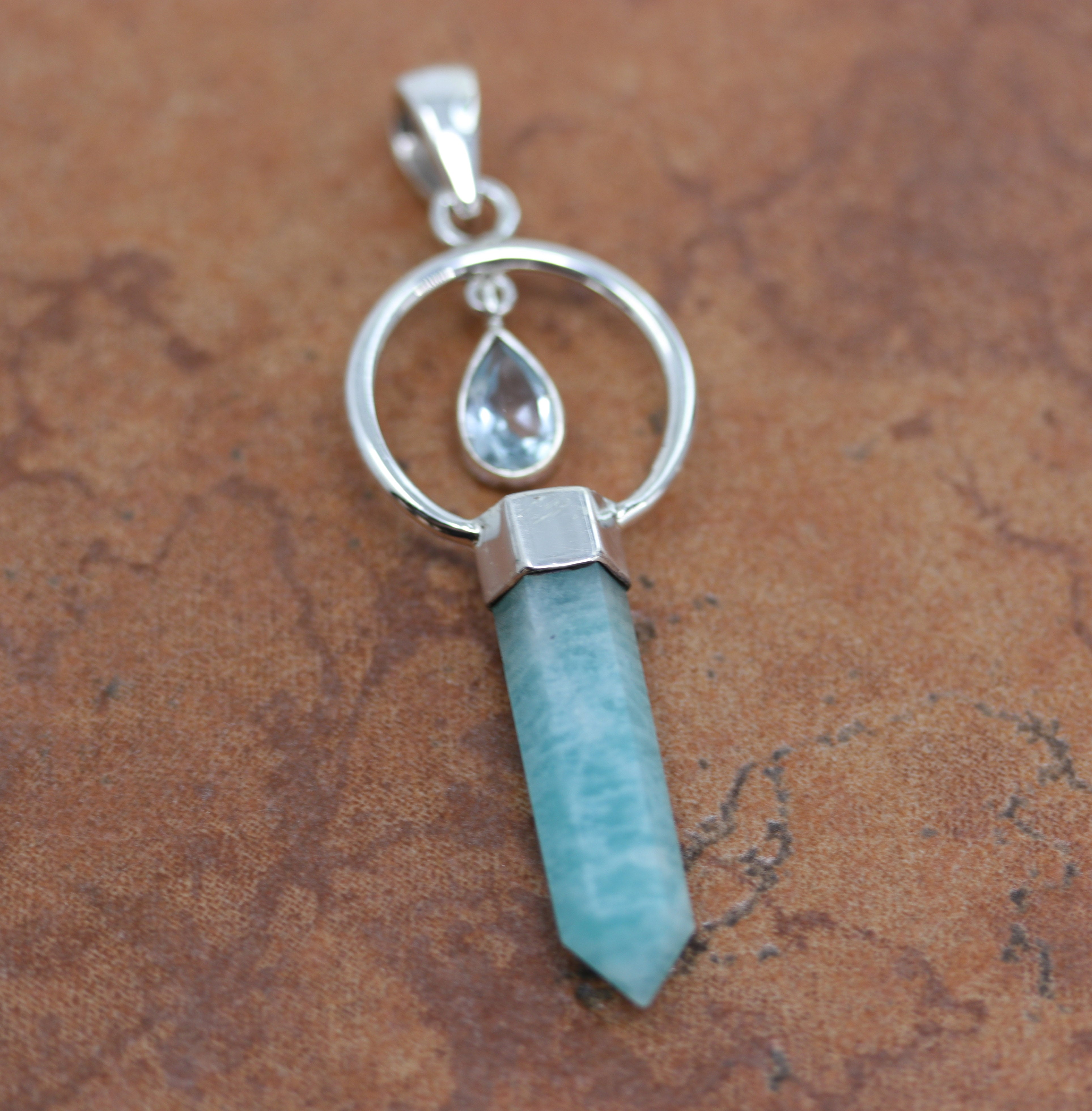 A lovely pendant made from sterling silver, aquamarine and larimar. The pendant is 2 3/4" in length including the bail, and 7/8" in width.