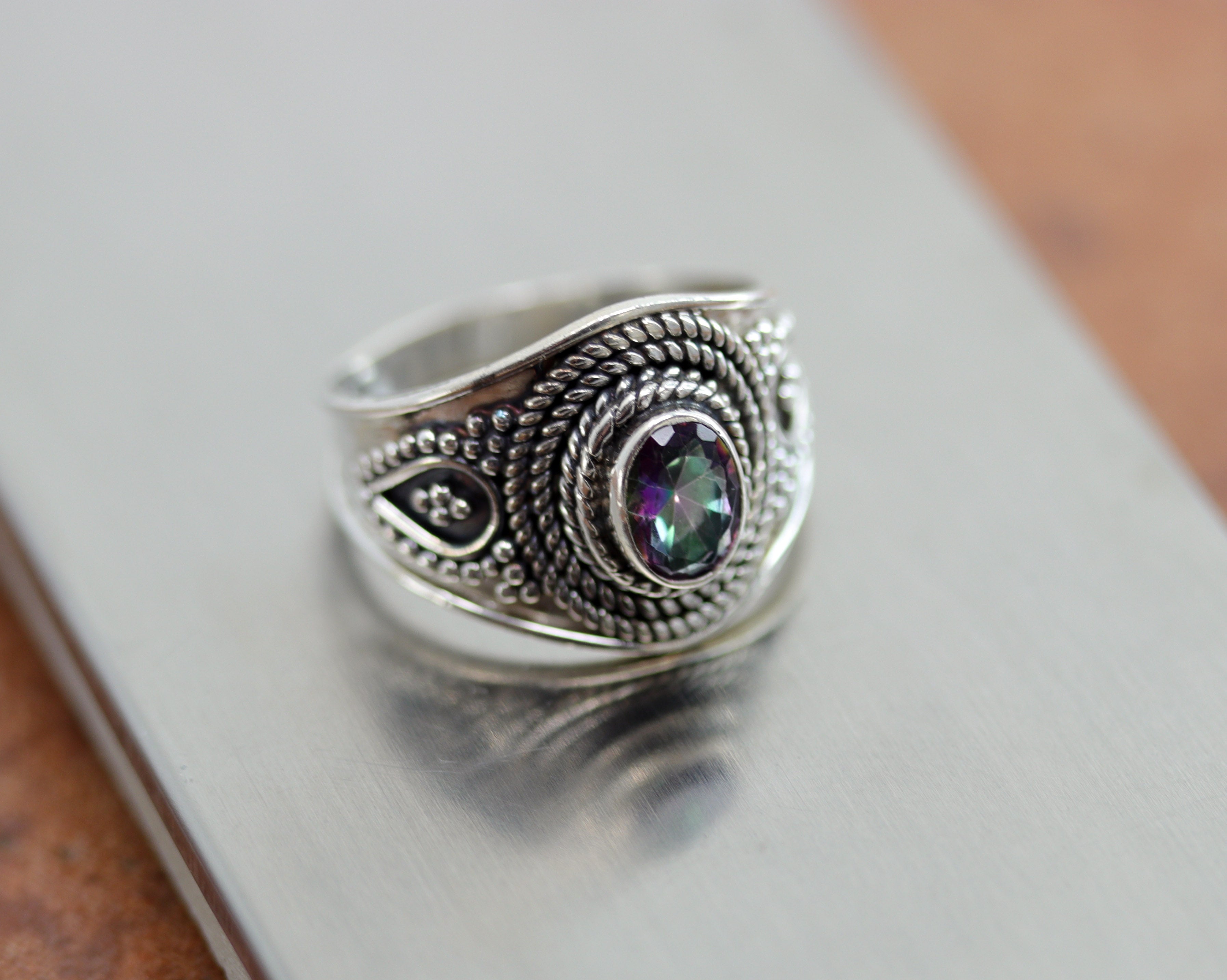 A beautiful Southwest Style gemstone ring made from sterling silver and mystic topaz. The ring size is 8 and it is about 3/4" in length. 