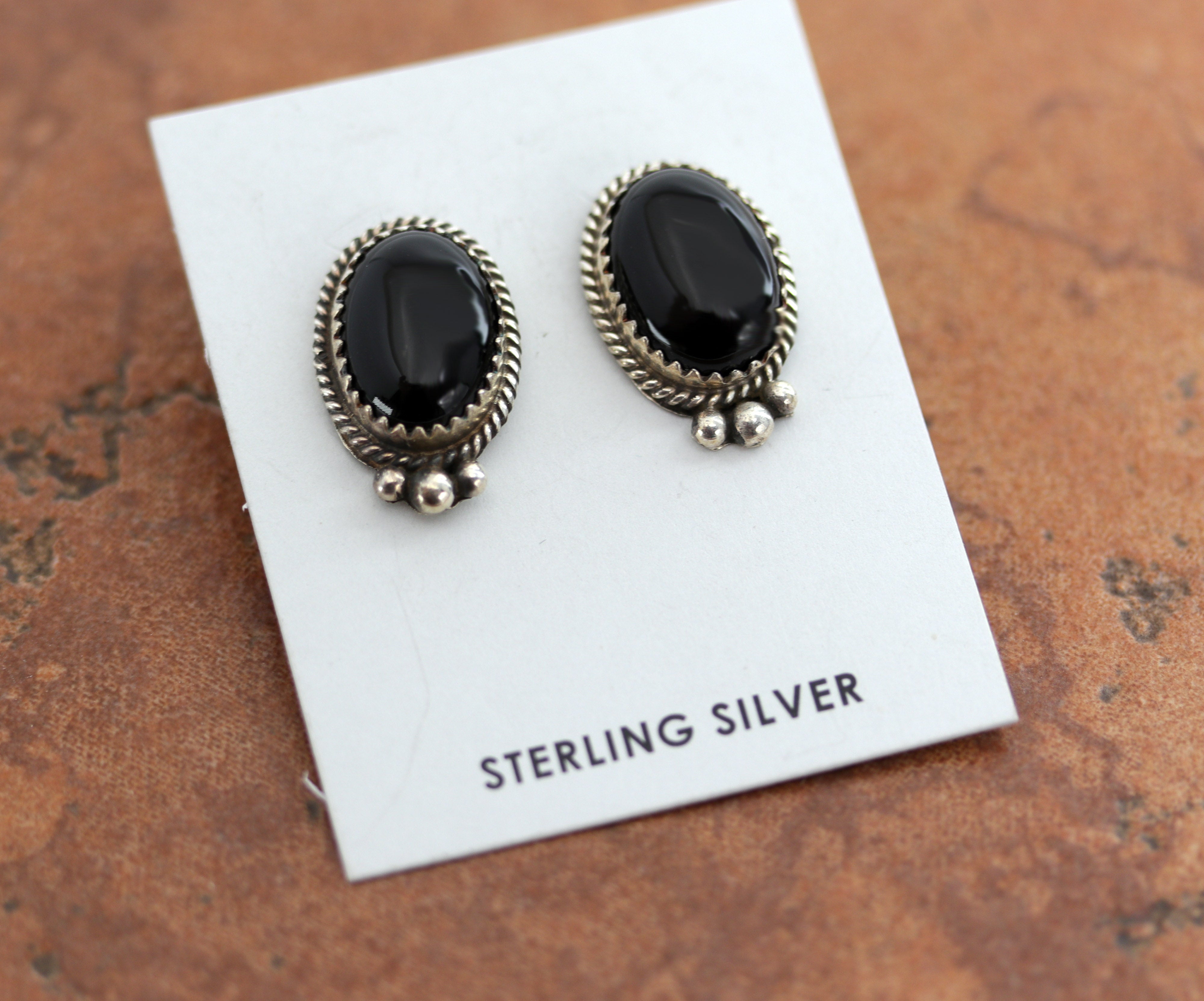 Navajo Native American earrings. They are made from sterling silver and onyx. The earrings are about 7/8" in length, and 9/16" in width.