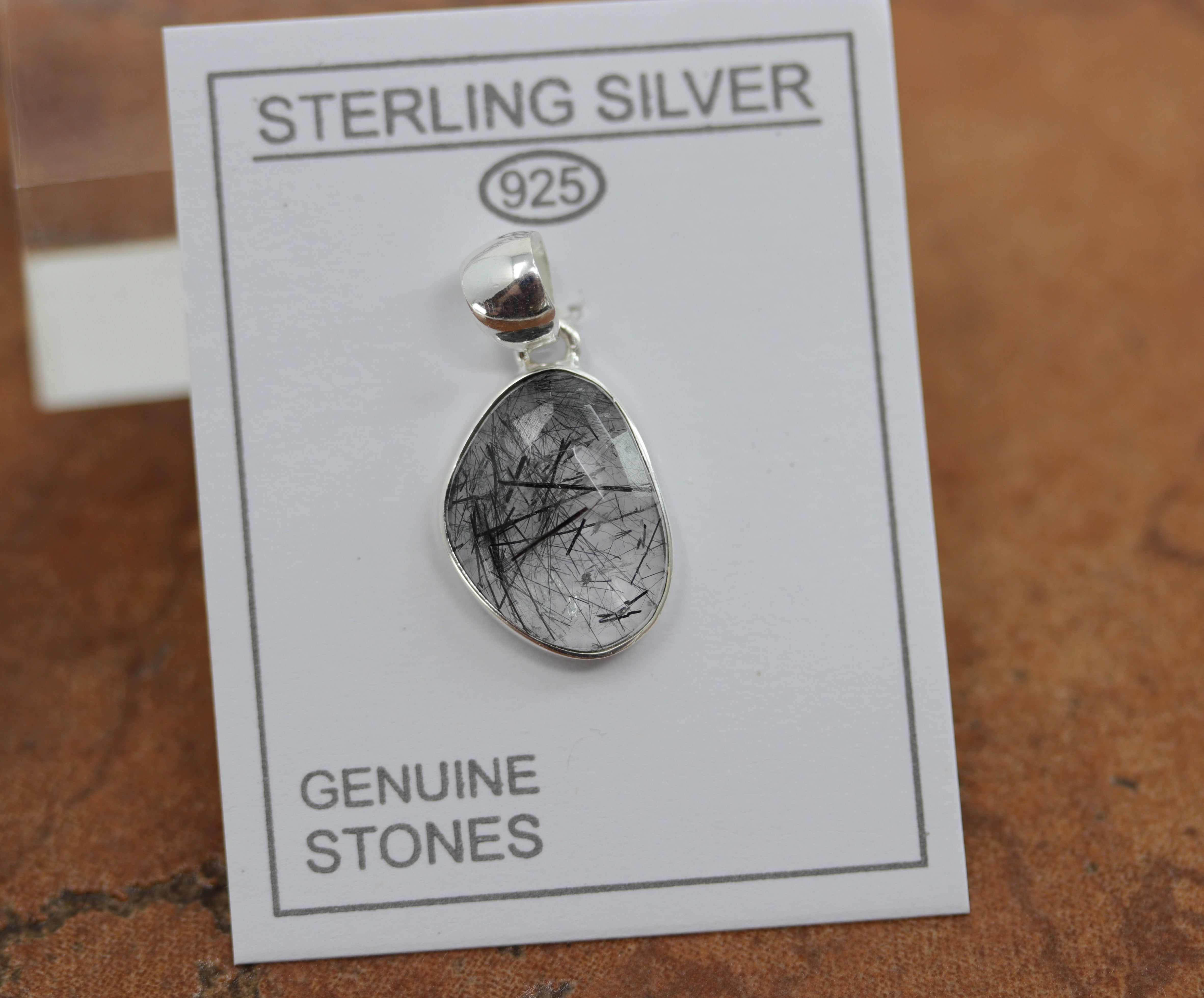 A beautiful pendant made from sterling silver and tourmalated quartz. The pendant is about 1 1/8" in length and 5/8" in width.