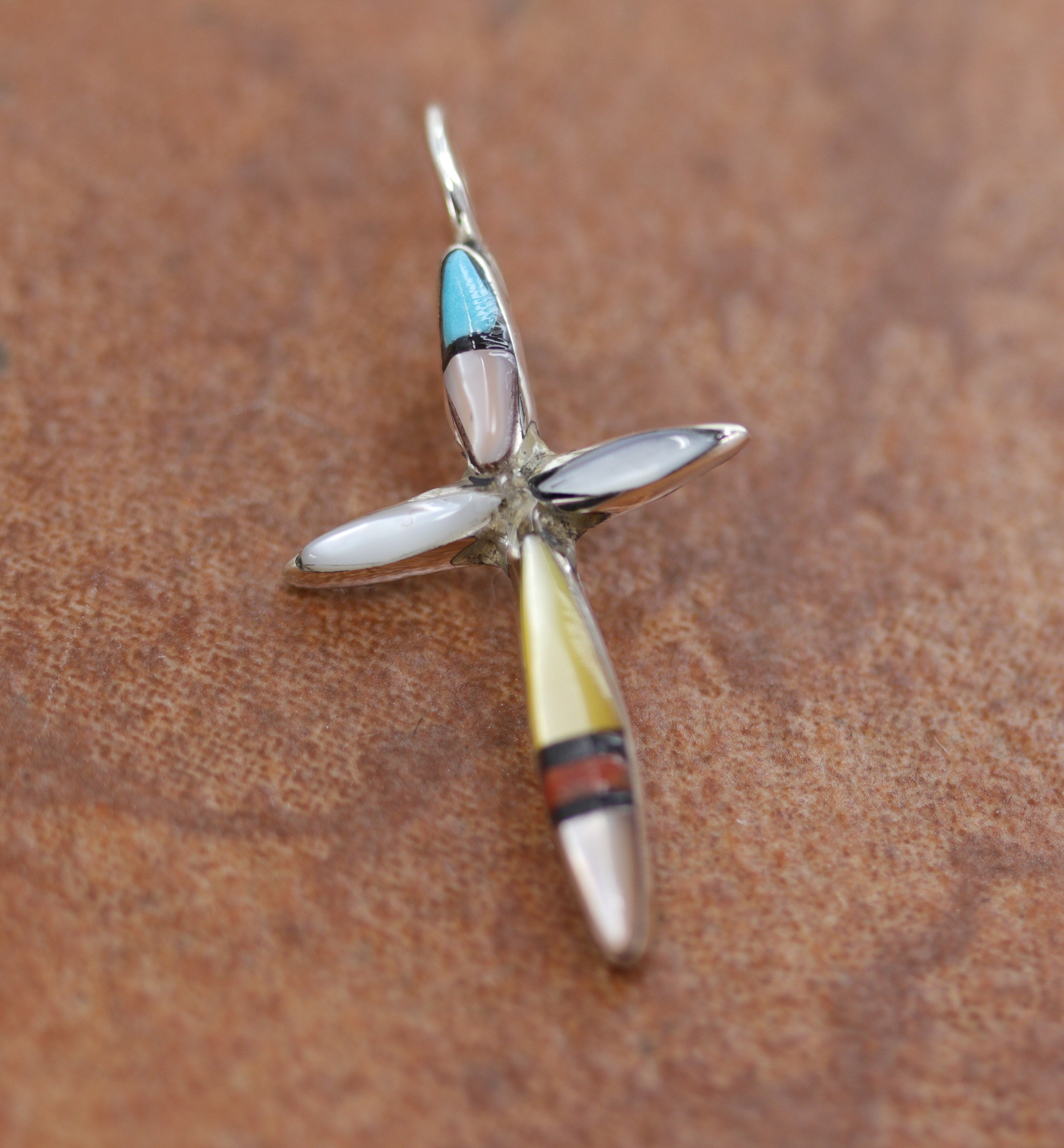 An authentic Zuni Native American Pendant. It is made from Sterling Silver and gemstones. It is about 1 1/4" in length including the bail, and about 3/4" in width.&nbsp;