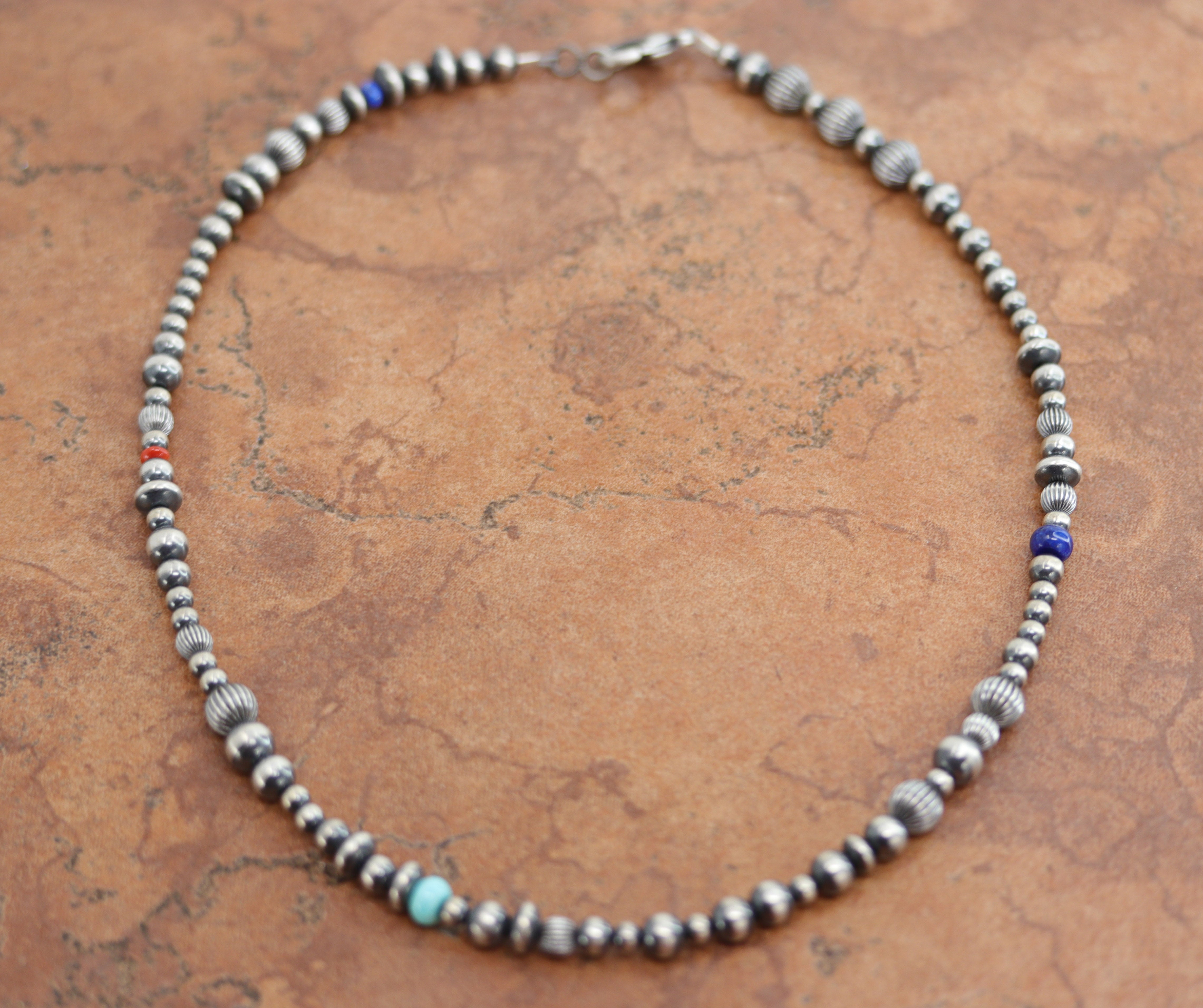 A beautiful silver Navajo Native American multi-stone necklace. The necklace is 18" in length and the beads measure 3/8".&nbsp;