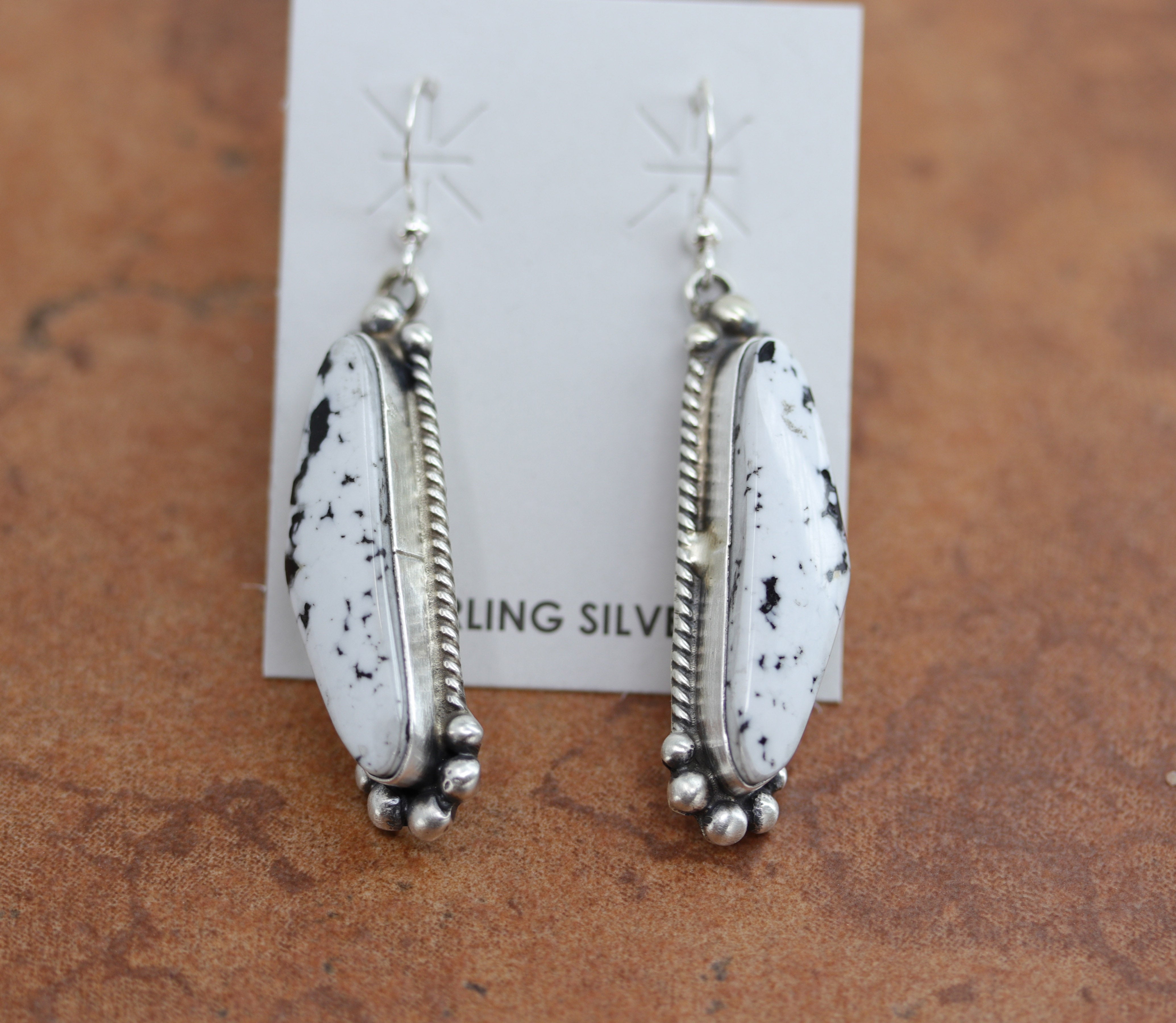 Beautiful Navajo Native American earrings. They are made from sterling silver and white buffalo. The earrings are about 2 1/4" in length, and 5/8" in width.