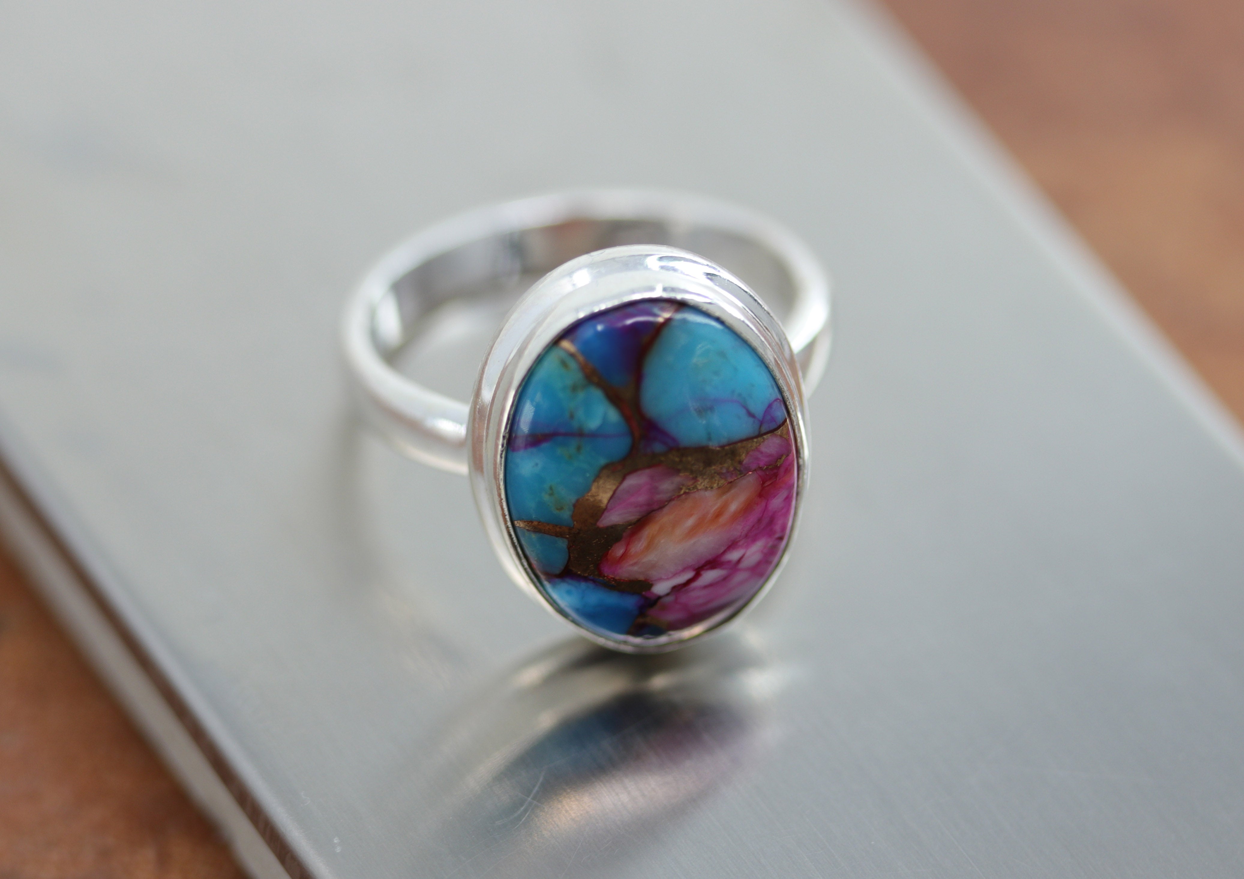 A beautiful Southwest Style gemstone ring made from sterling silver and mojave turquoise. The ring size is 8 and it is 3/4" in length. 