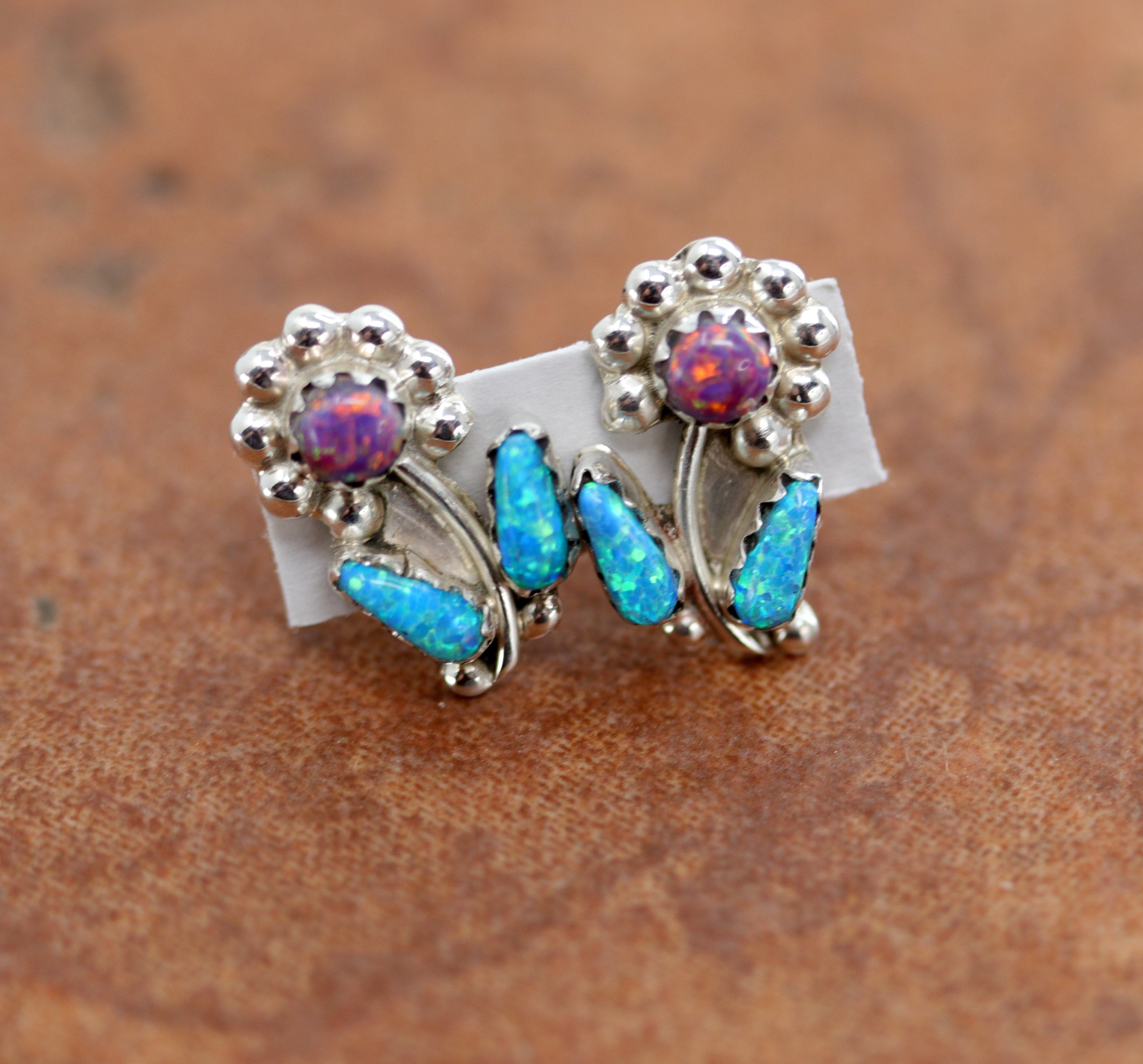 Beautiful Zuni Native American earrings. They are made from sterling silver and created opal. Each earring is 5/8" in length, and about 3/8" in width.