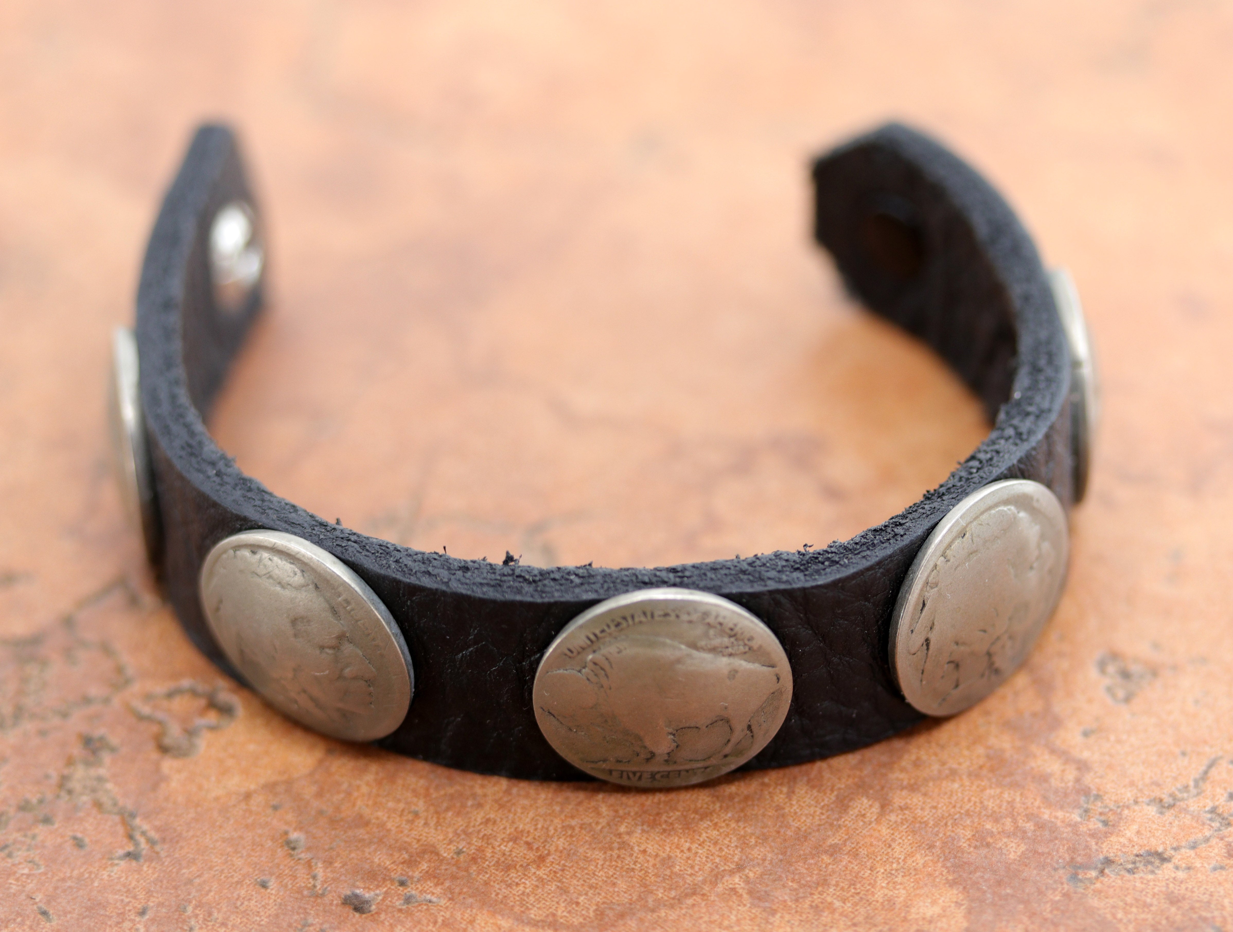 Lovely Navajo Native American leather bracelet. It is made from leather and buffalo nickels. It is about 7 1/2" in length and 3/4" wide.