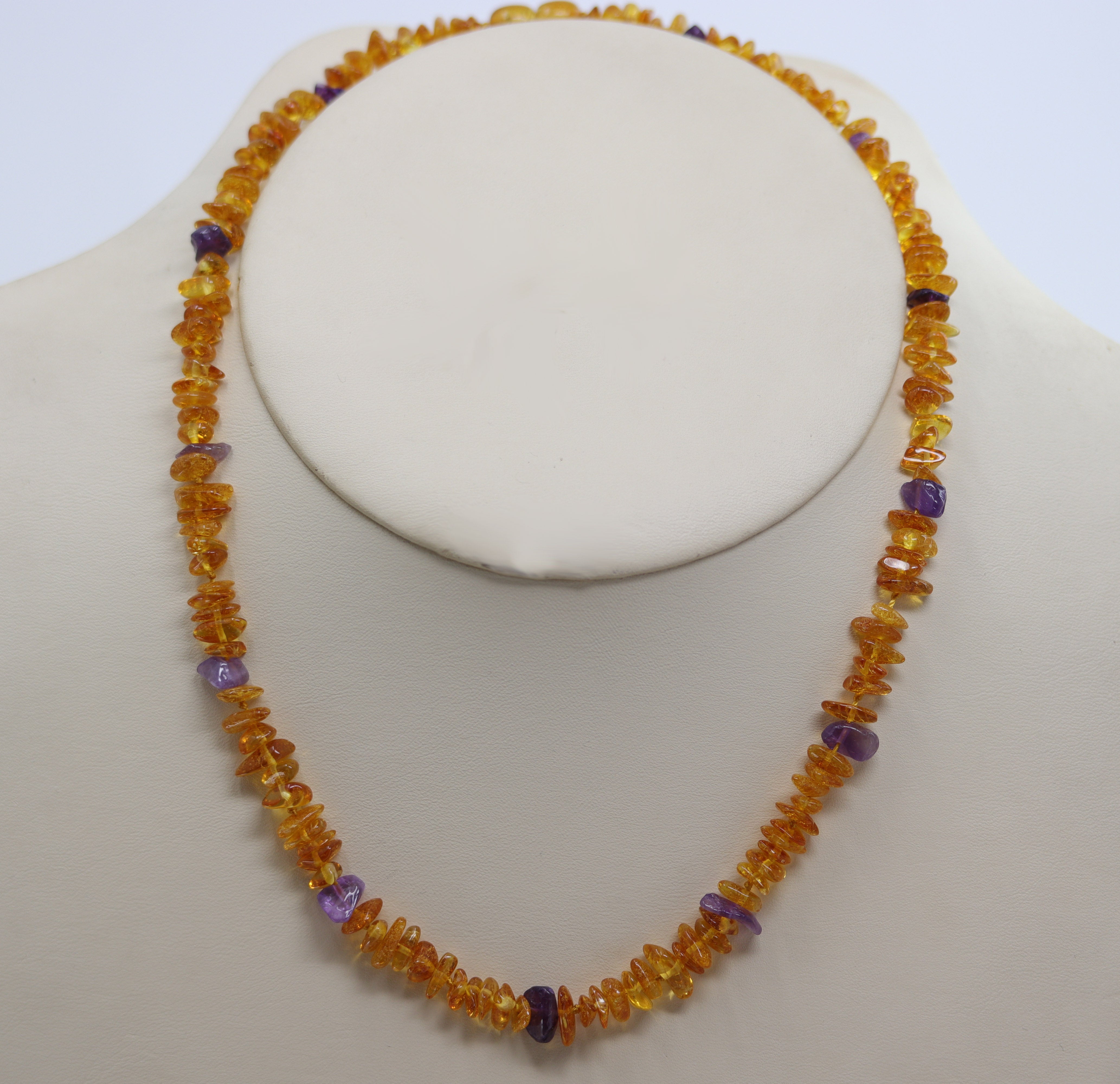 A beautiful amber and amethyst beaded necklace. The amber comes from the Baltic Sea. The necklace is about 19 1/2" in length, and about 1/2" wide. 