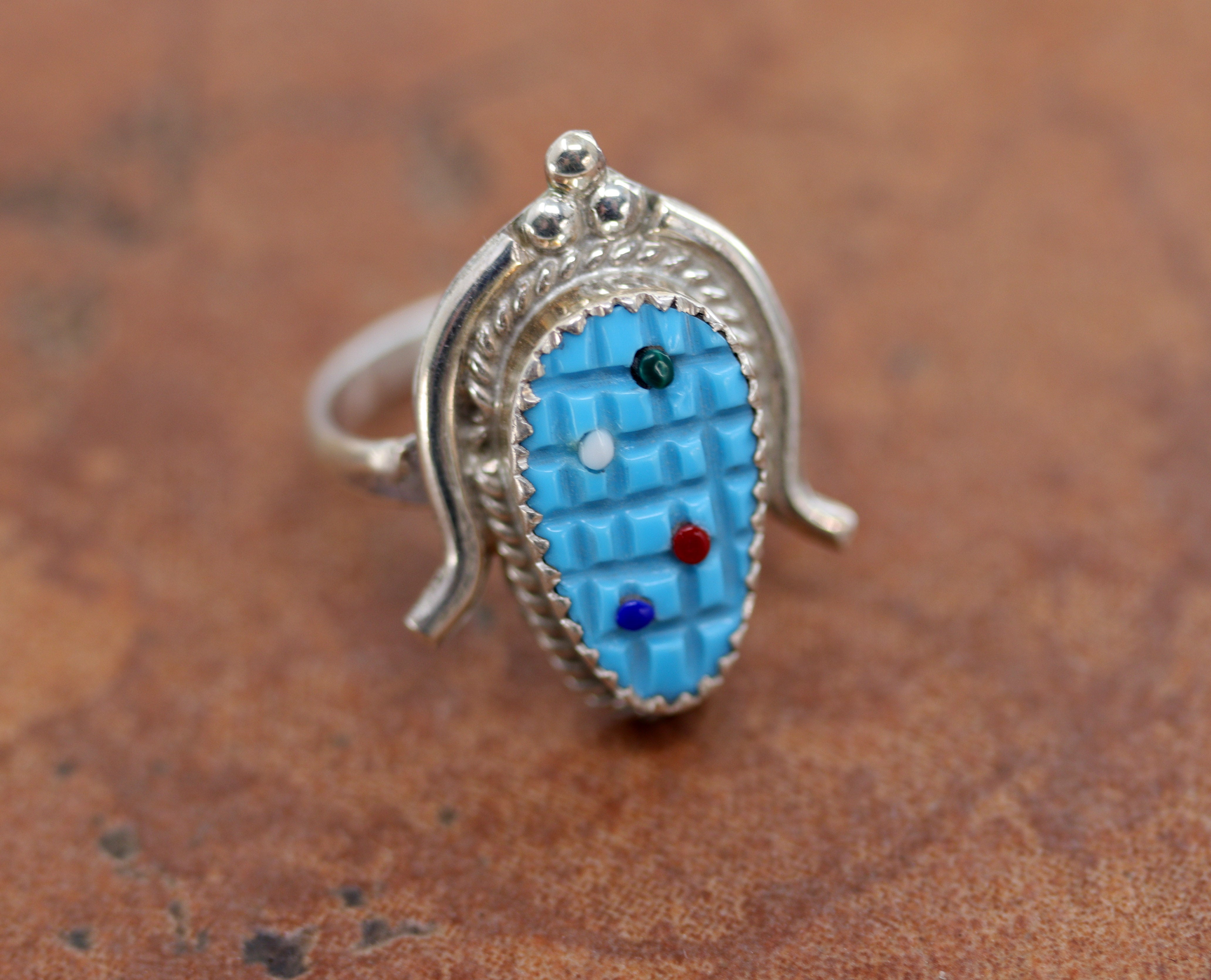 Beautiful Zuni Native American ring. It is made from sterling silver and multi-stone. The ring size 7 1/2 and it is 1" in length.&nbsp;