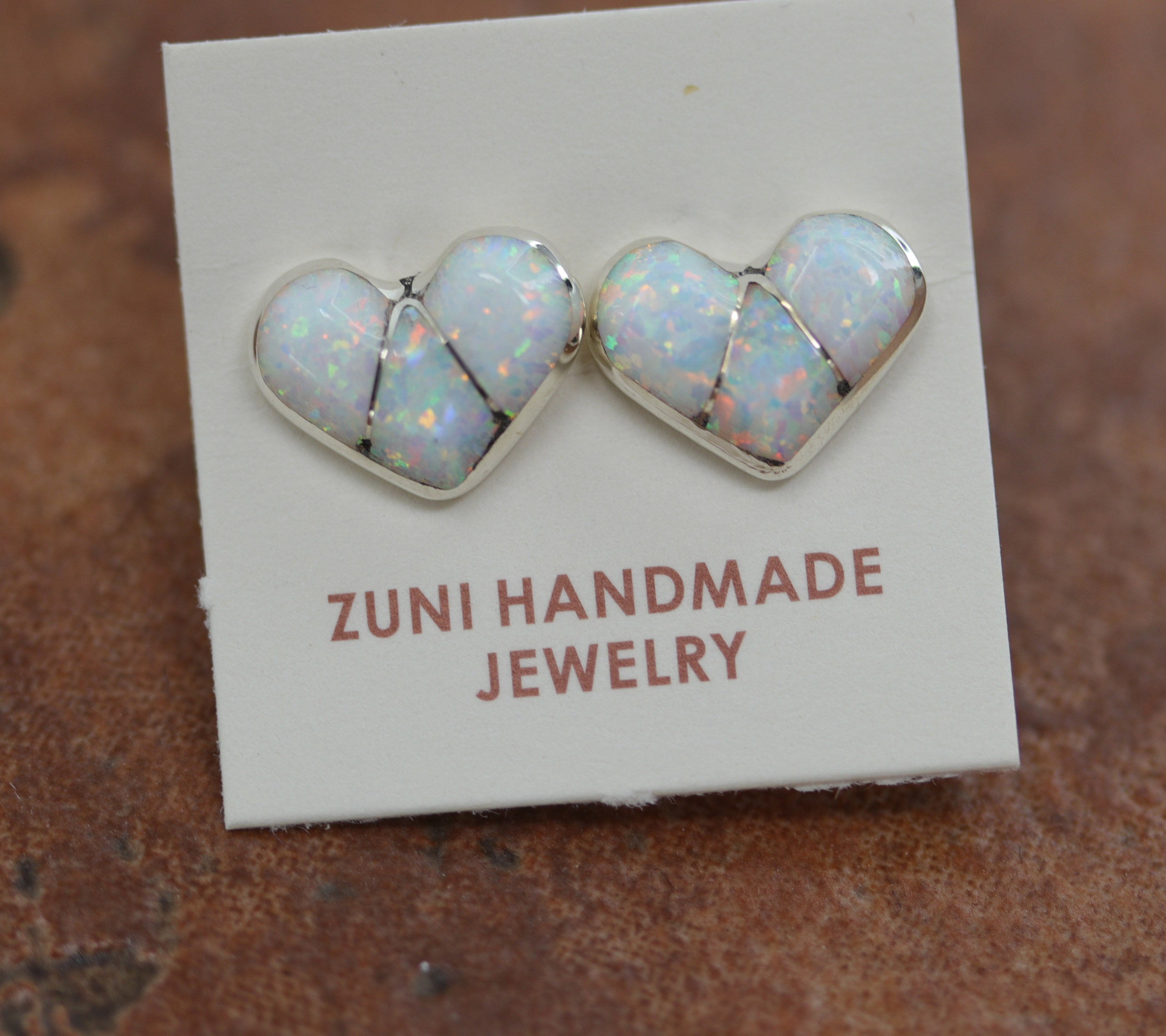 Beautiful Zuni Native American heart earrings. They are made from sterling silver and created opal. Each earring is 3/8" in length, and about 3/8" in width.