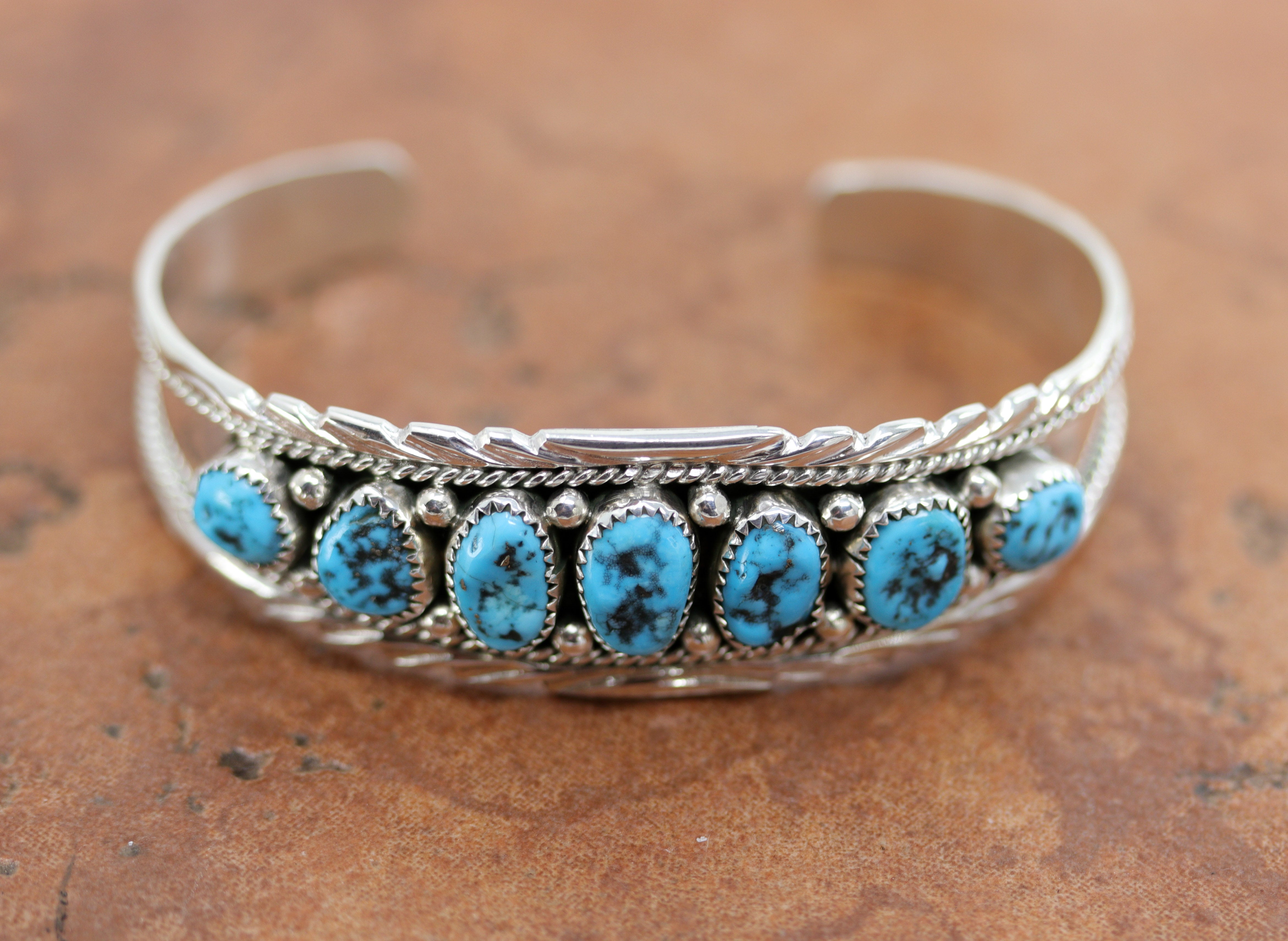 Beautiful Navajo Native American bracelet. It is made from sterling silver and turquoise. It is about 5 1/4" around and 3/4" wide. The opening is about 1", and partly flexible.