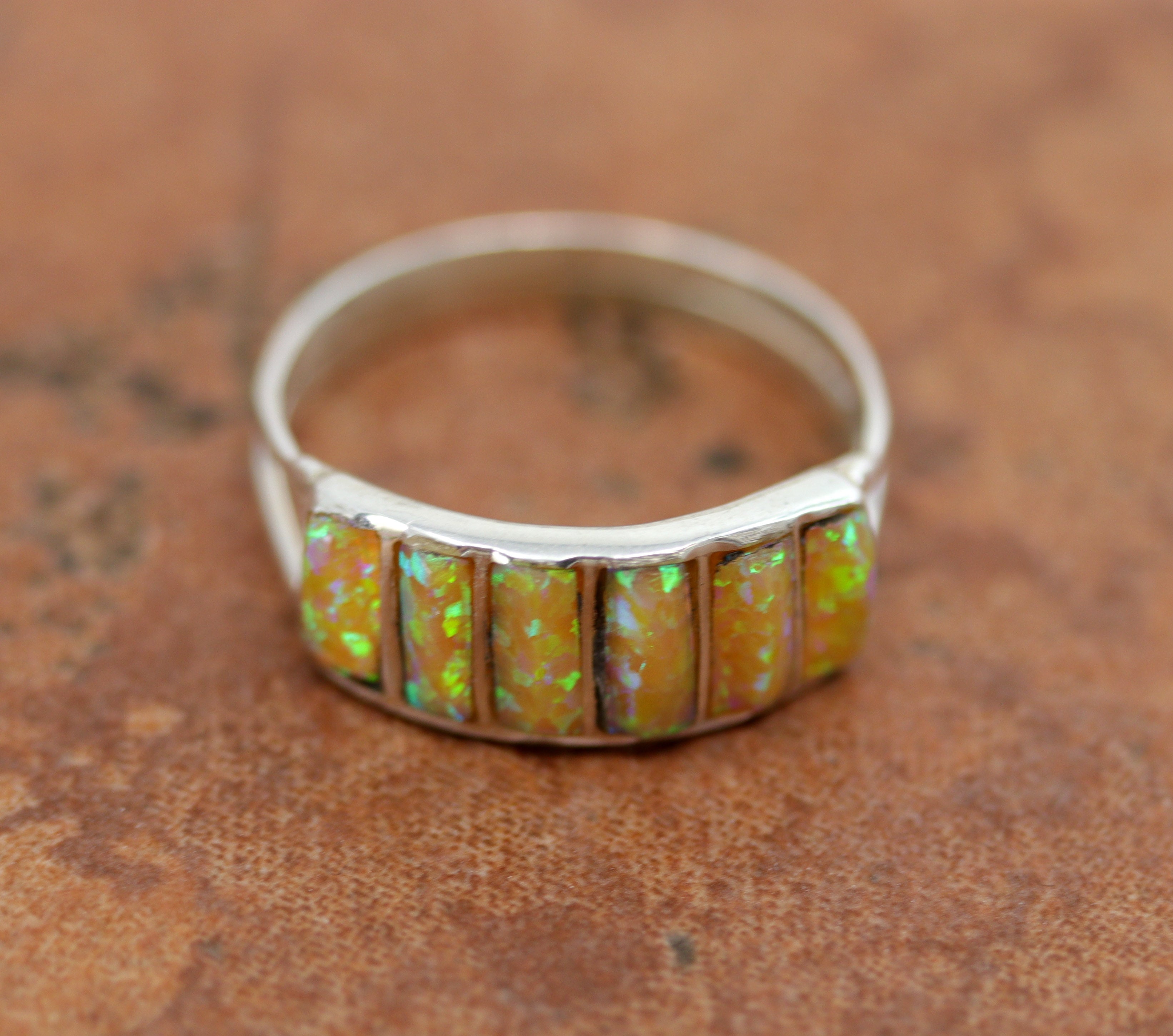 A lovely Navajo Native American ring. It is made from sterling silver and created opal. The ring size 8 and it is 5/16" in length.