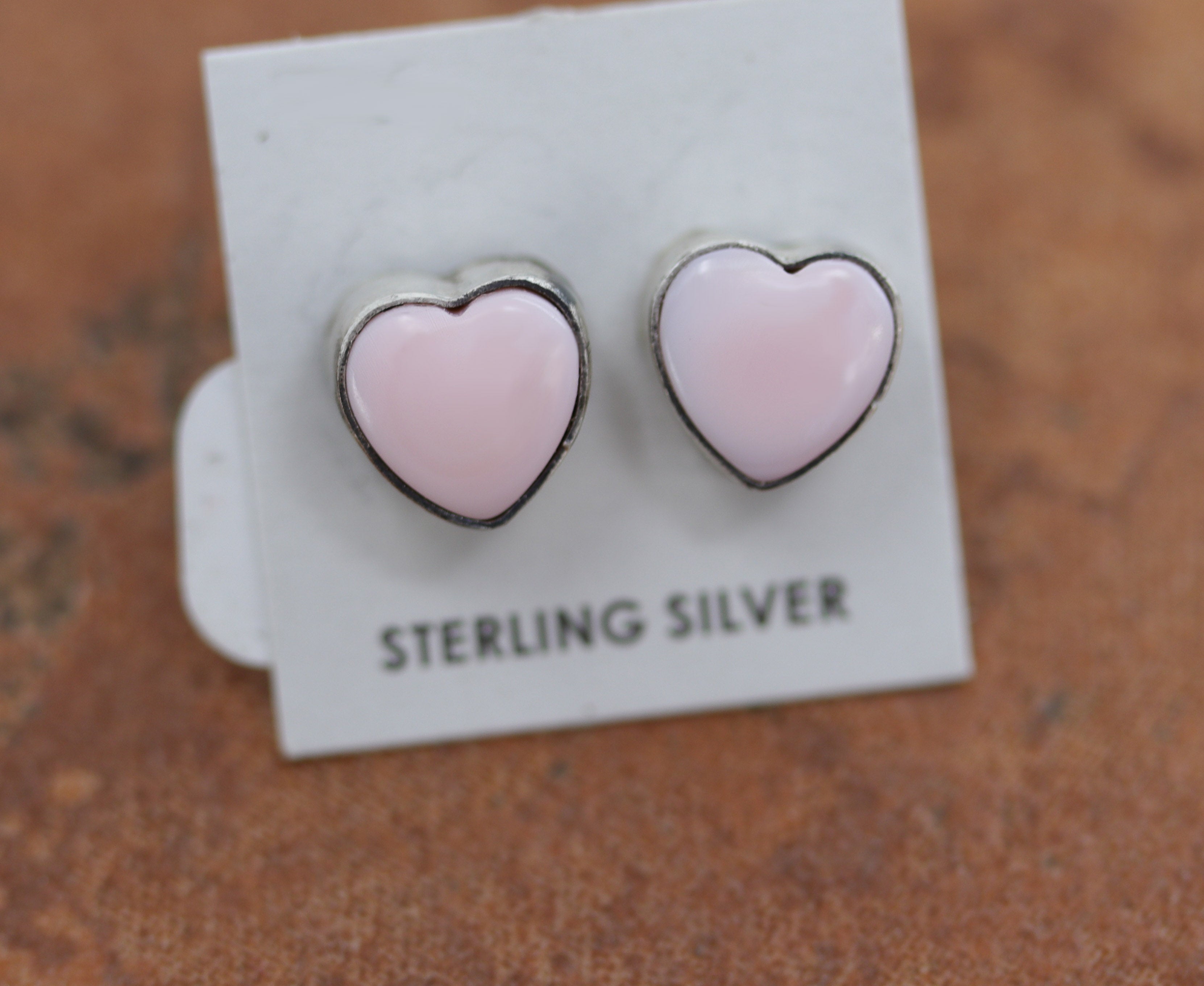 Beautiful Navajo stud heart earrings. They are made from sterling silver and pink quartz. The earrings are 3/8" in length.