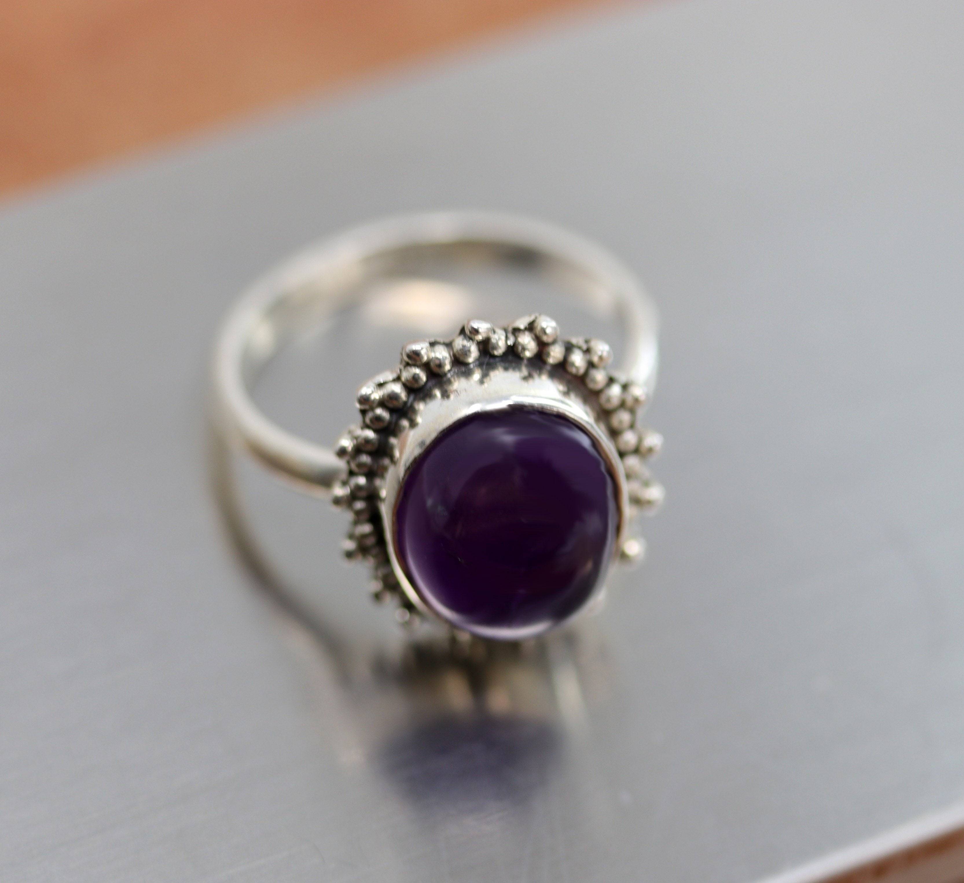 A beautiful Southwest Style gemstone ring made from sterling silver and amethyst. The ring size is 7 and it is 3/4" in length. 