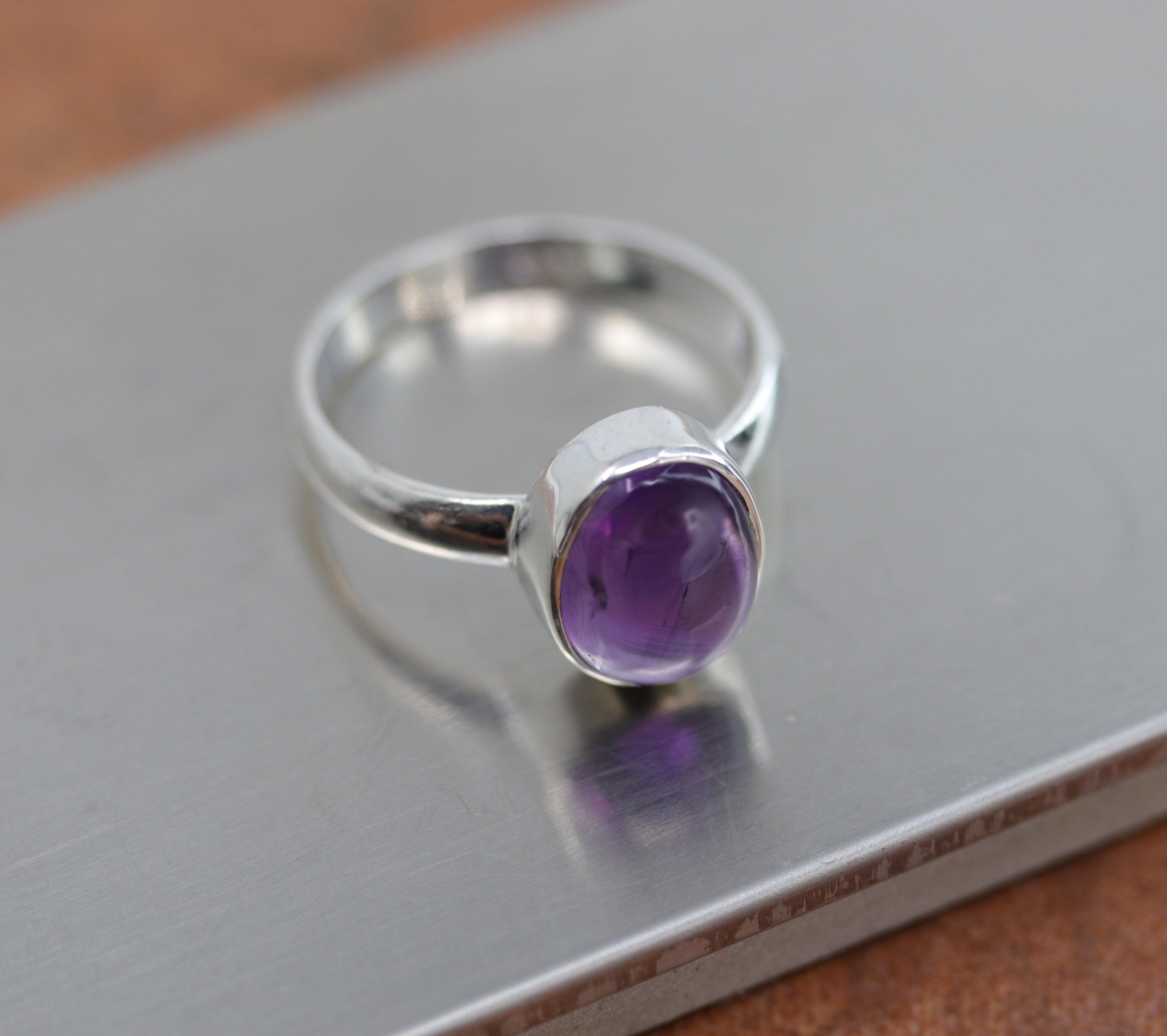 A beautiful Southwest Style gemstone ring made from sterling silver and amethyst. The ring size is 8 and it is 1/2" in length.