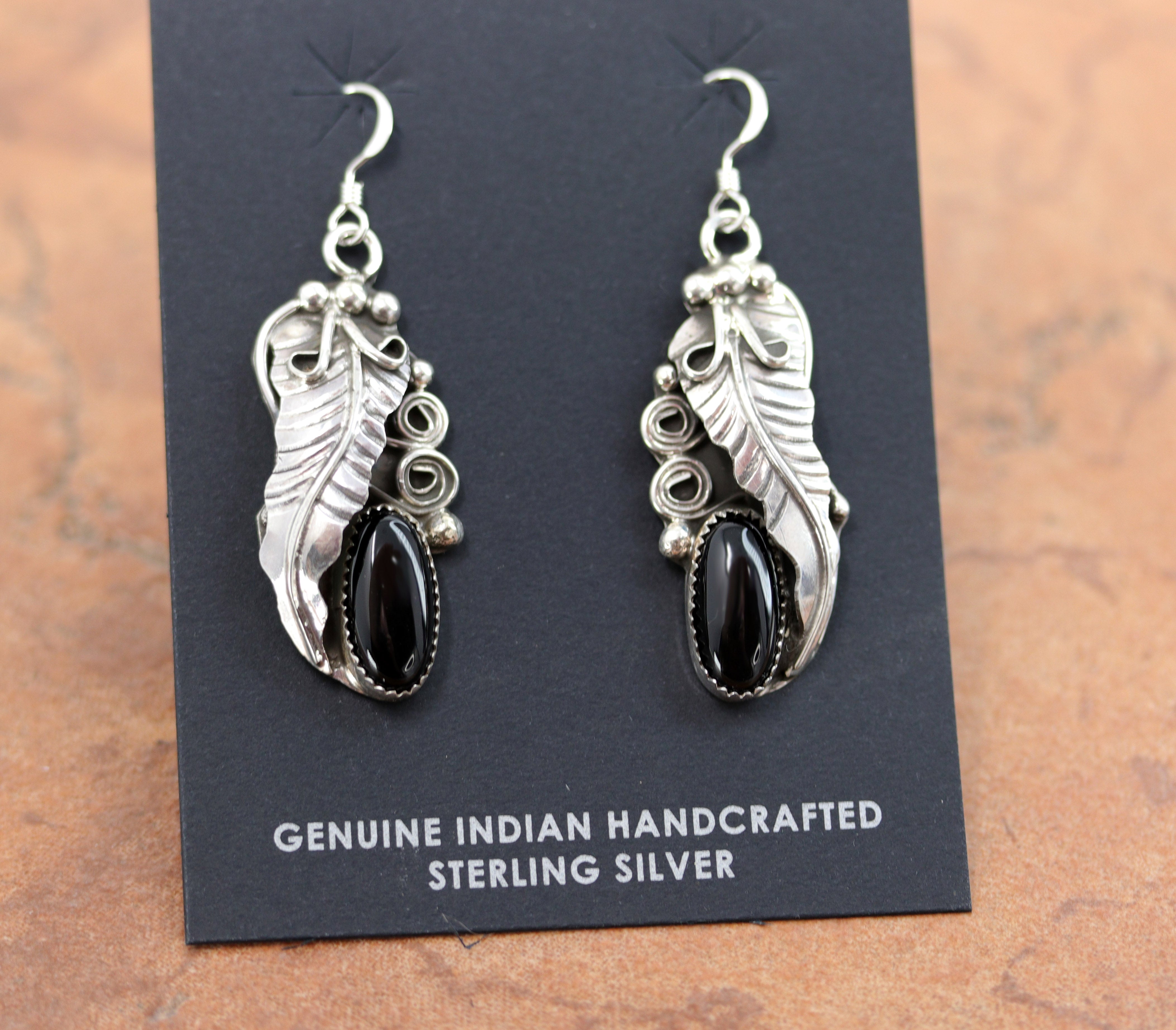 A beautiful Navajo Native American earrings. They are made from sterling silver and onyx. The earrings are about 2" in length including the hook and 5/8" wide.&nbsp;