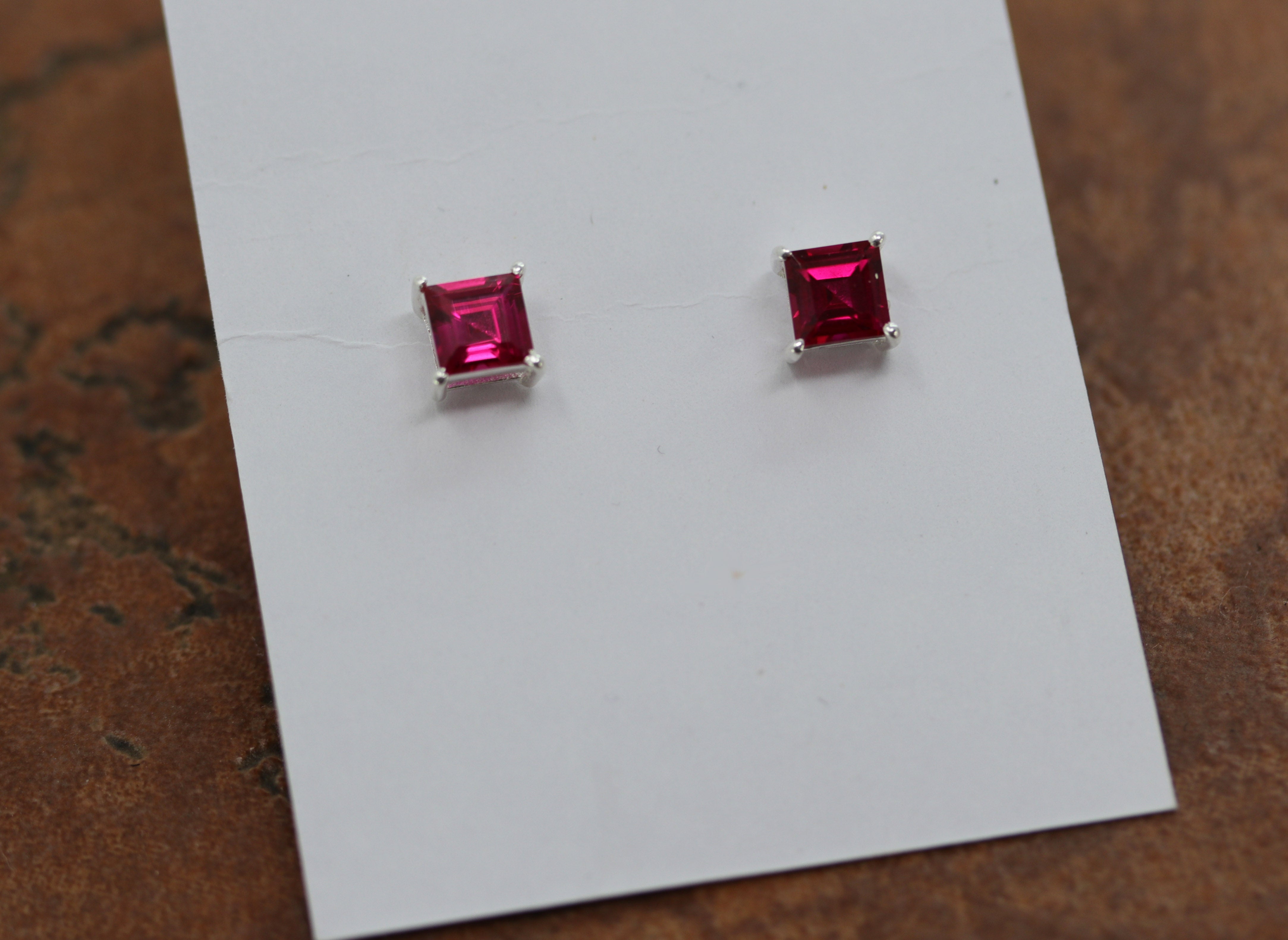 Beautiful stud earrings made from sterling silver and imitation ruby. The earrings about 1/4" in width.