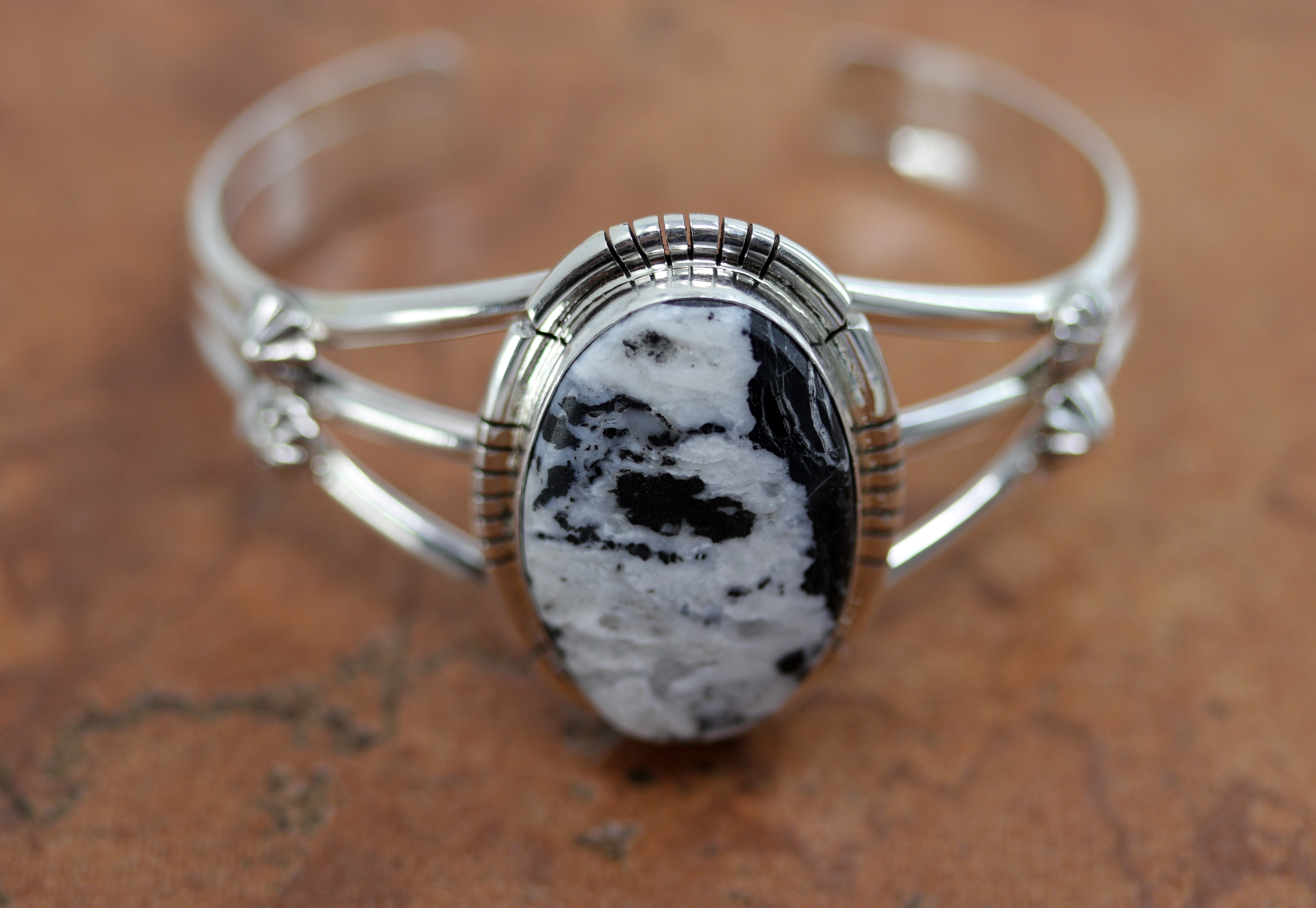 Navajo Native American bracelet. It is made from sterling silver and white buffalo. It is about 5 1/4" around and 1 1/2" wide. The opening is about 1", and it is partly flexible.&nbsp;