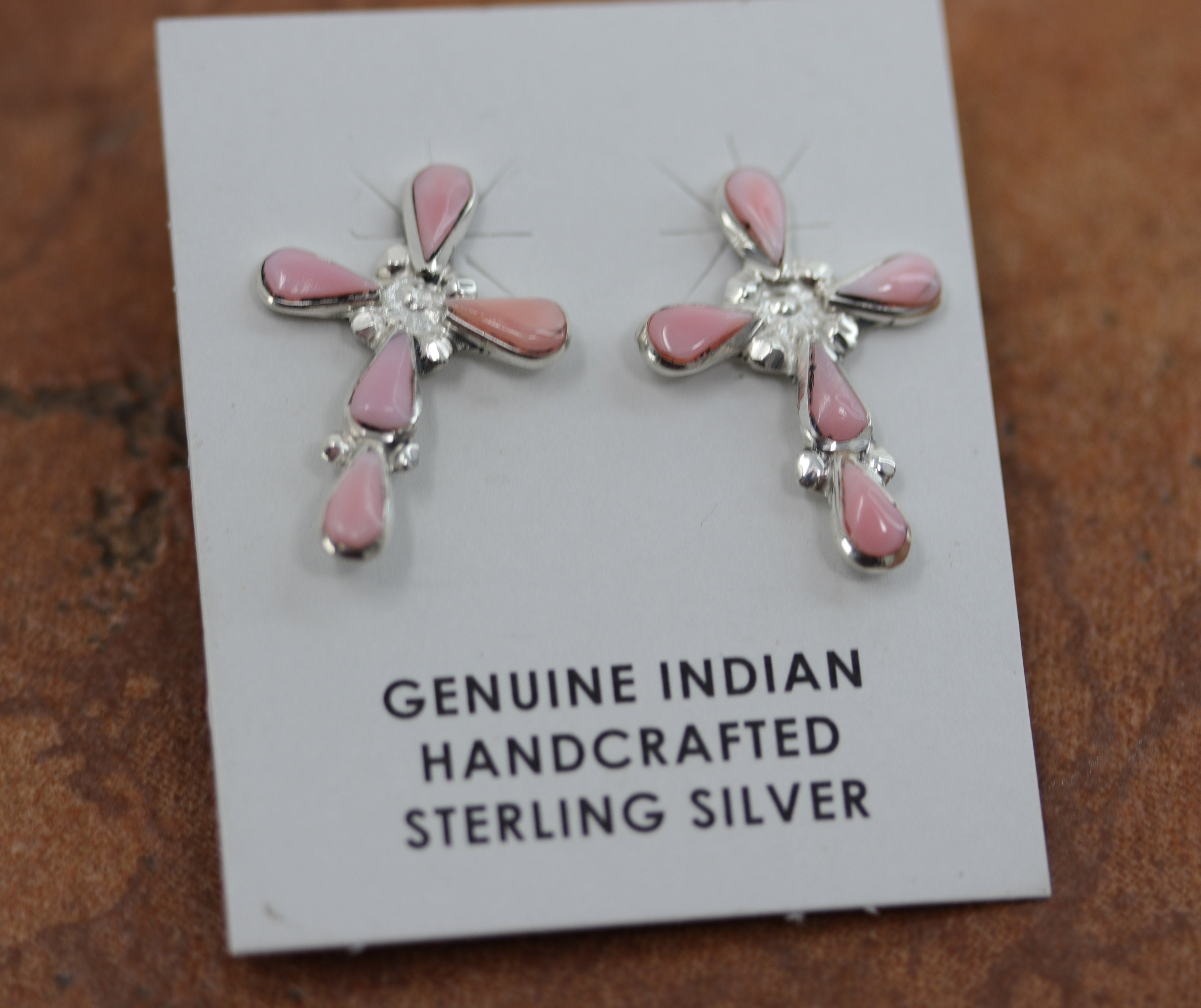 Beautiful Zuni Native American Cross earrings. They are made from sterling silver and created opal. Each earring is 1" in length, and about 3/4" in width.