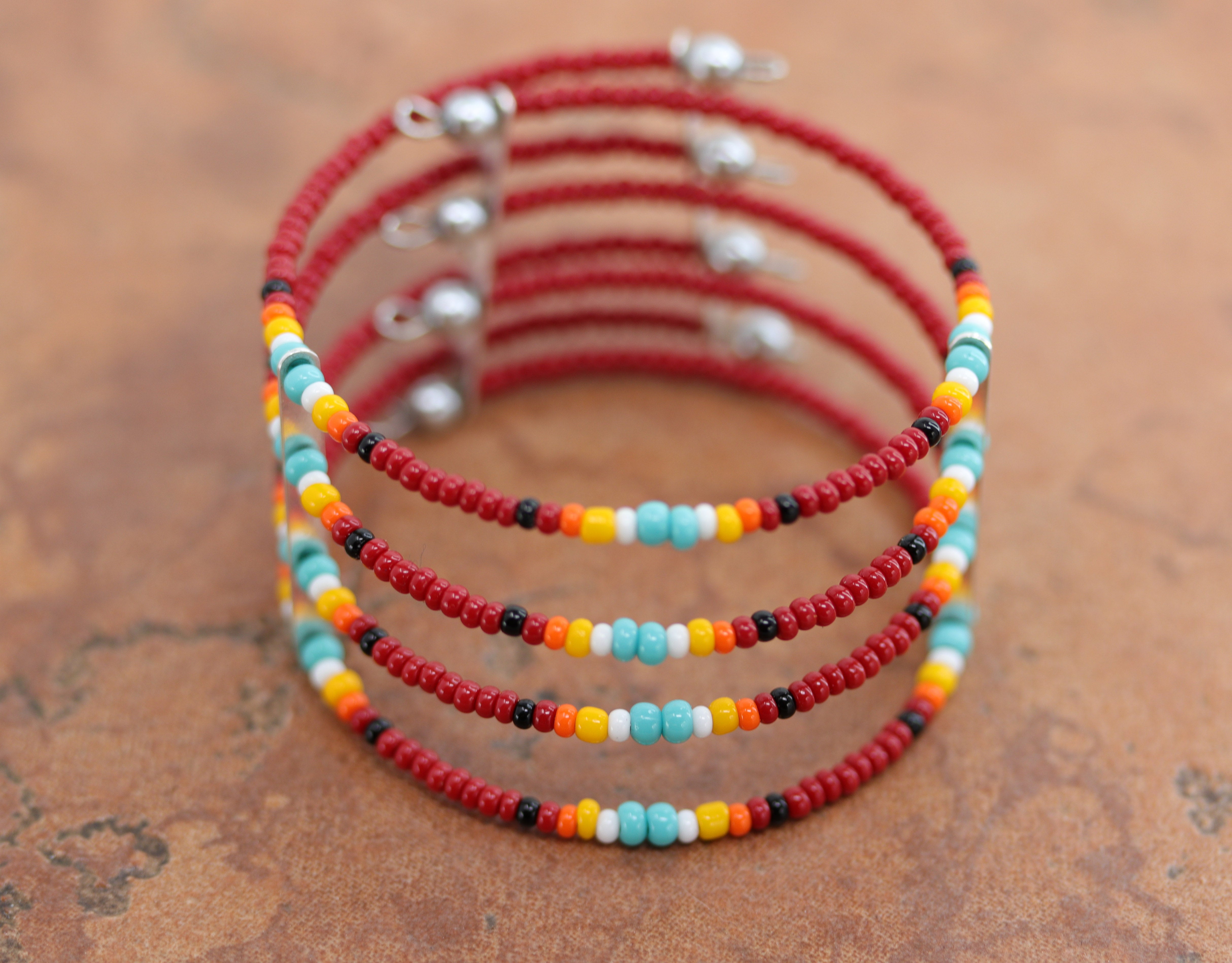 A beautiful Navajo Native American beaded bracelet. It is about 6 3/4" from end to end and the width is 1 1/8". The bracelet is very flexible so it will fit many different sizes.