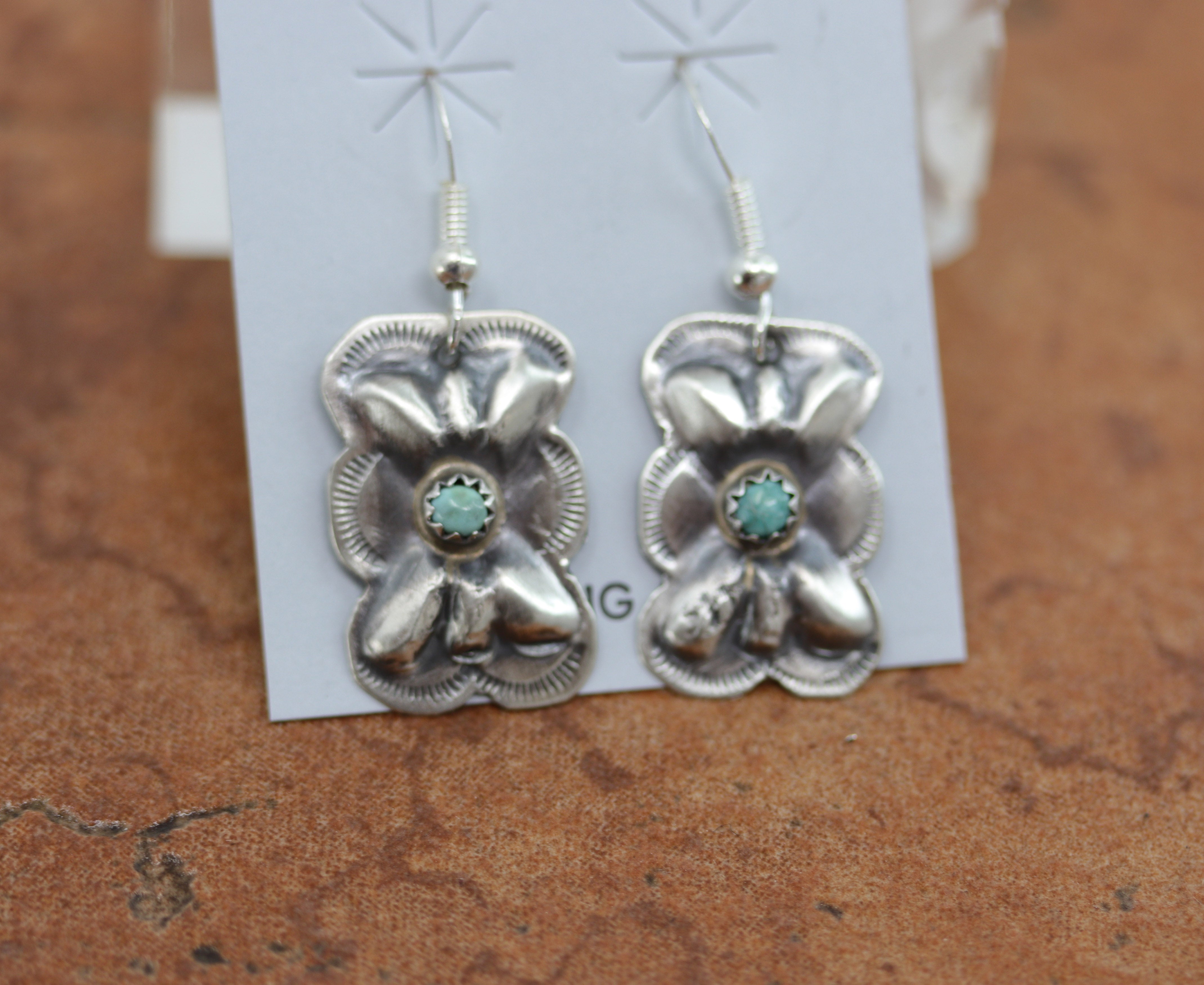 Navajo Native American earrings. They are made from sterling silver and turquoise. The earrings are 1 /2" in length including the hook and 5/8" in width.