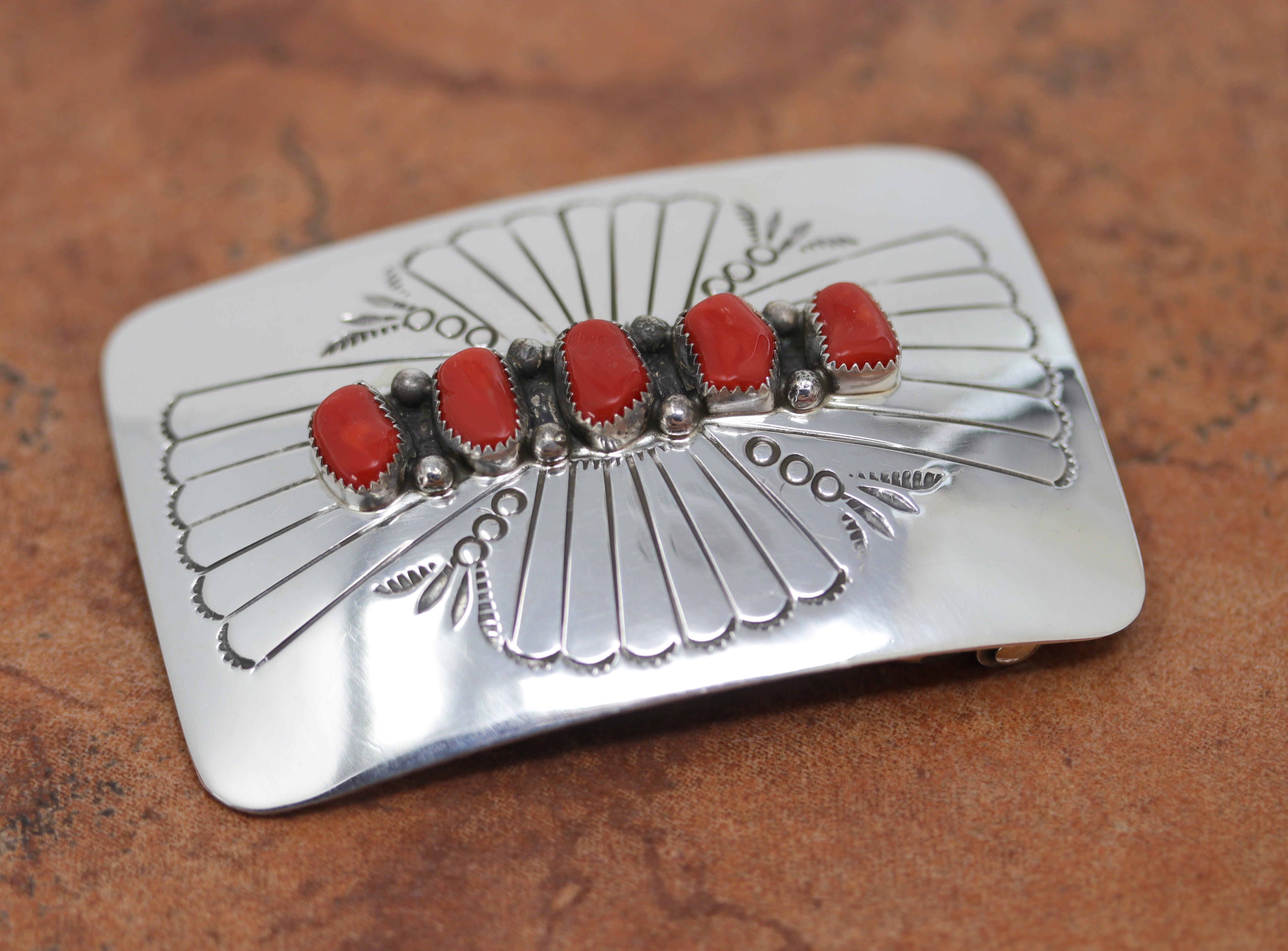 Authentic, Navajo Native American Belt Buckle. It is made from sterling silver and coral. It is stamped Sterling. It is 3" by 2 1/4". It will hold a belt up to 1 1/2" wide.