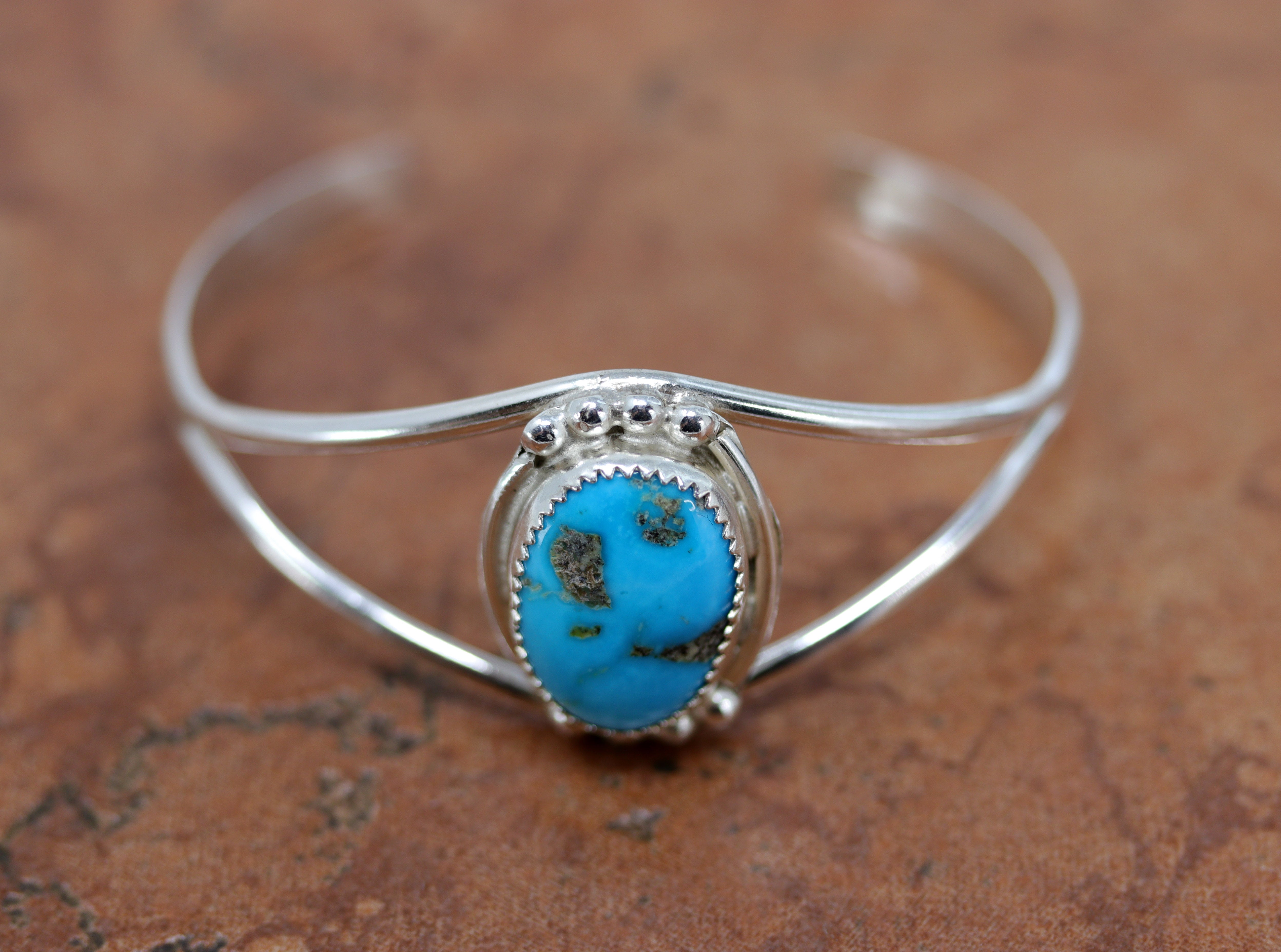 Beautiful Navajo Native American bracelet. It is made from sterling silver and turquoise. It is about 5 5/8" around and about 1 1/8". The opening is about 1" and partly flexible.