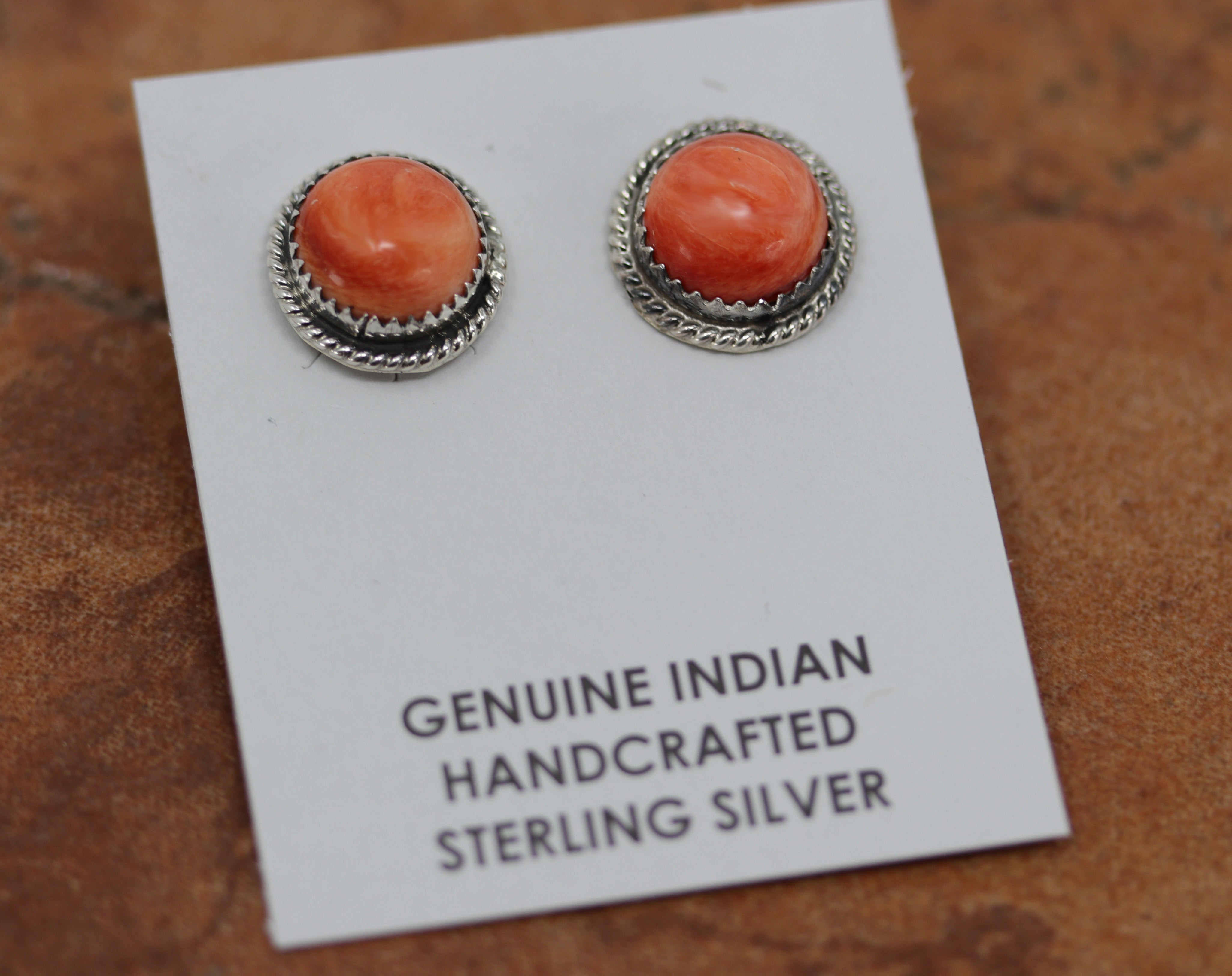 Beautiful Navajo Native American earrings. They are made from sterling silver and spiny oyster. The earrings are about 1/2" in diameter.