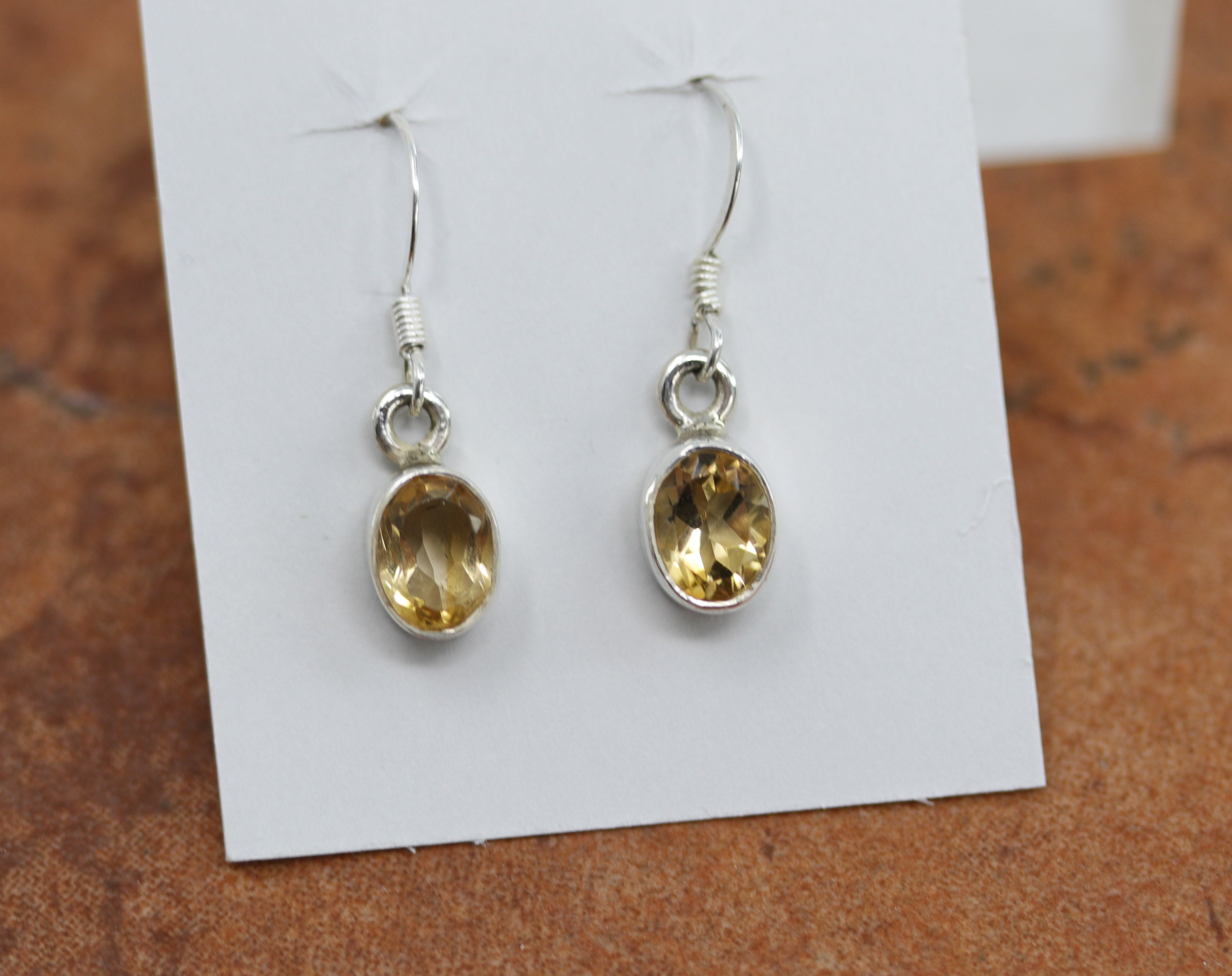 Beautiful earrings made from sterling silver and citrine . The earrings are about 1 1/4" in length including the hook and 3/8" in width.