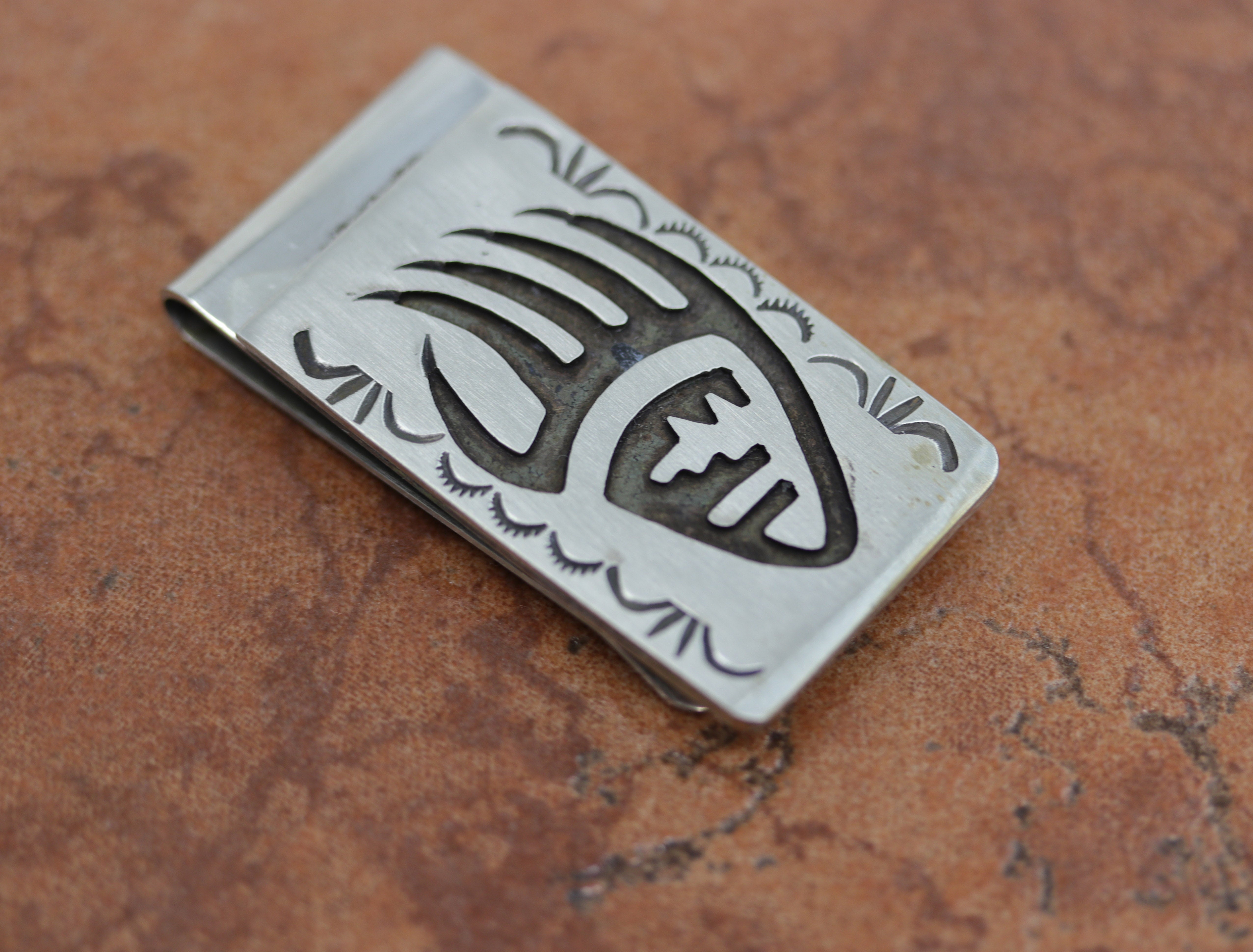 A brand new, very nice, authentic Native American money clip. It is made from sterling silver. The lower part of the money clip is made from nickel to give it more durability. It is about 2" in length and 1" wide.