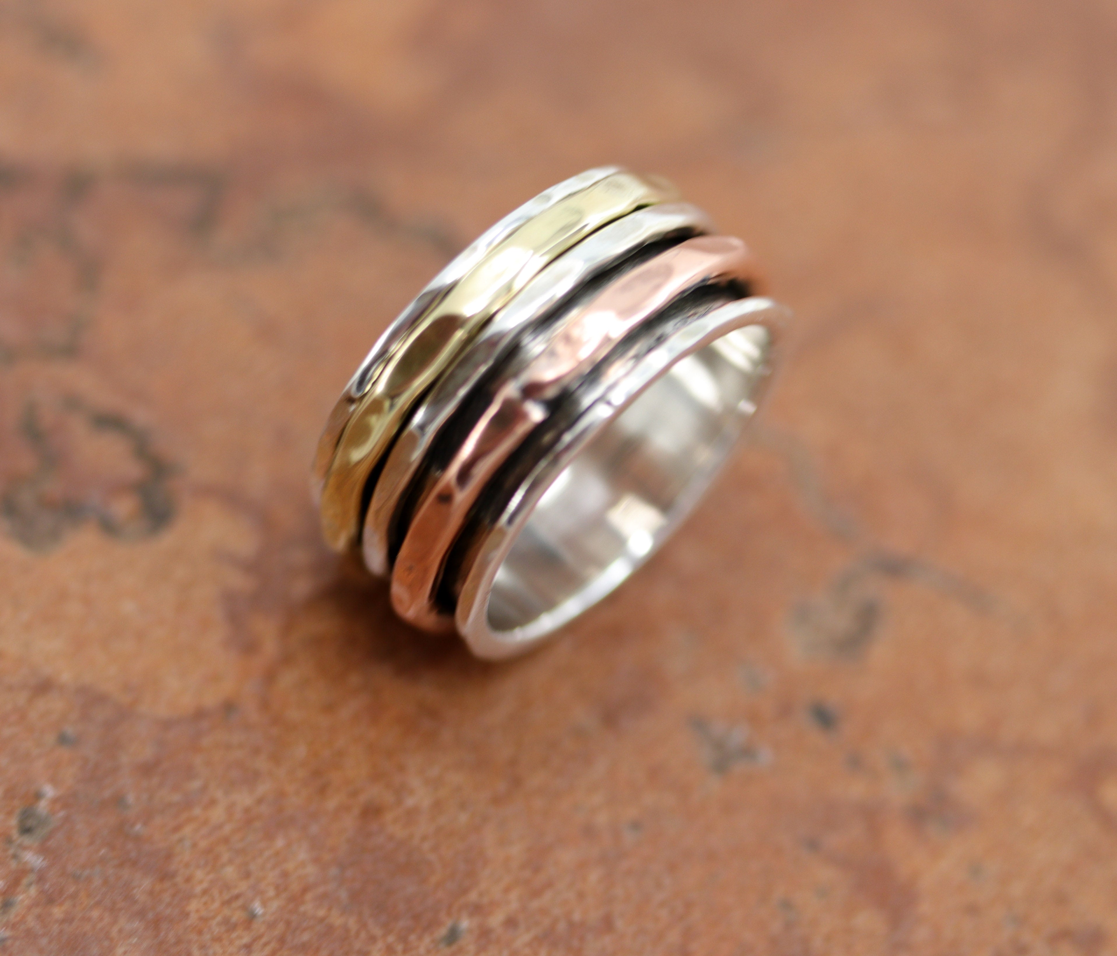 A beautiful Southwest Style tri-color ring made from sterling silver, bronze, and copper. The ring size is 8 1/2 and it is 9/16" in length.