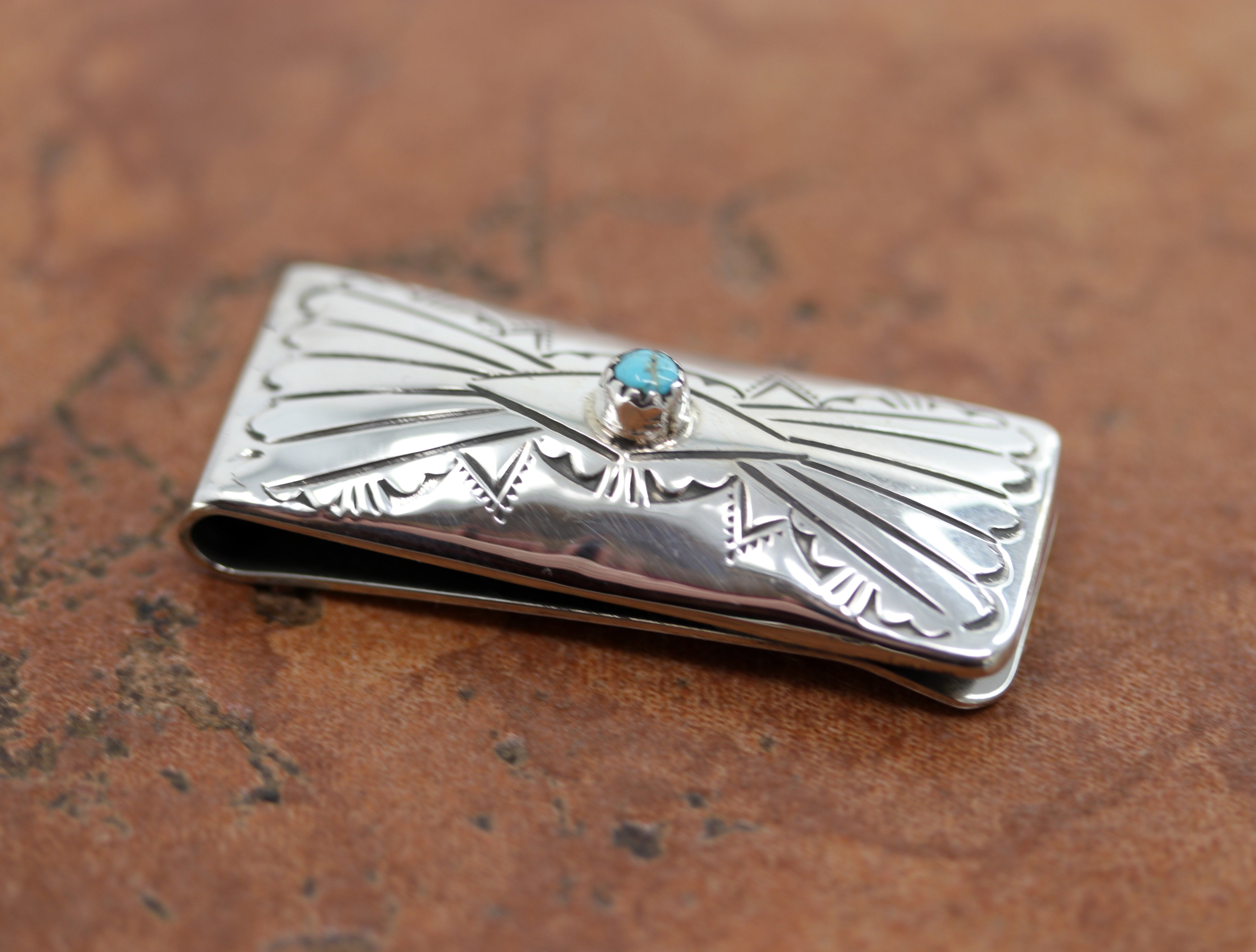 A brand new, very nice, authentic Native American money clip. It is made from sterling silver and turquoise. The lower part of the money clip is made from nickel to give it more durability. It is about 1 7/8" in length and 3/4" wide.