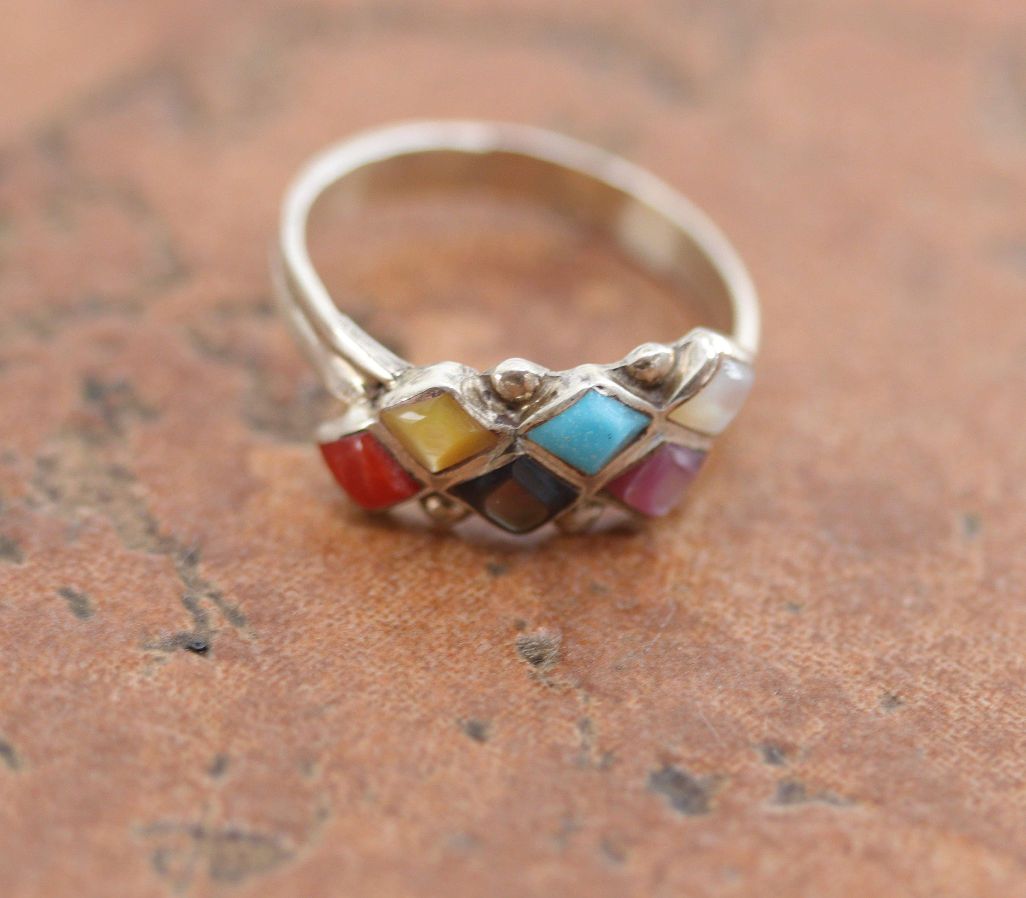 Zuni Native American ring. It is made from sterling silver and multi-stone inlay. The ring size 7 and it is 3/8" in length.