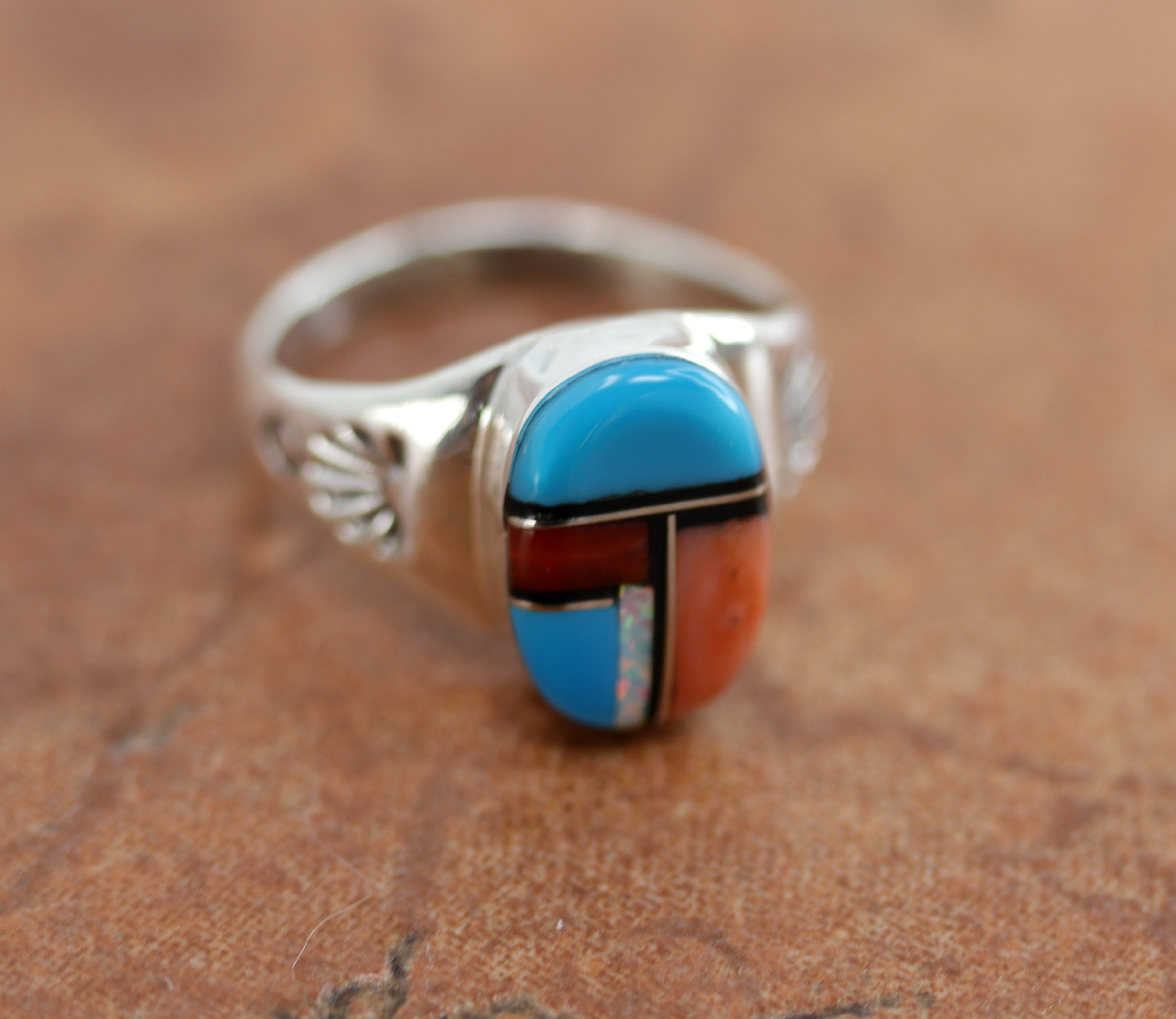 Navajo Native American ring. It is made from sterling silver and multi-stone inlay. The ring size 7 1/2 and it is 5/8" in length. It is stamped by the artist.